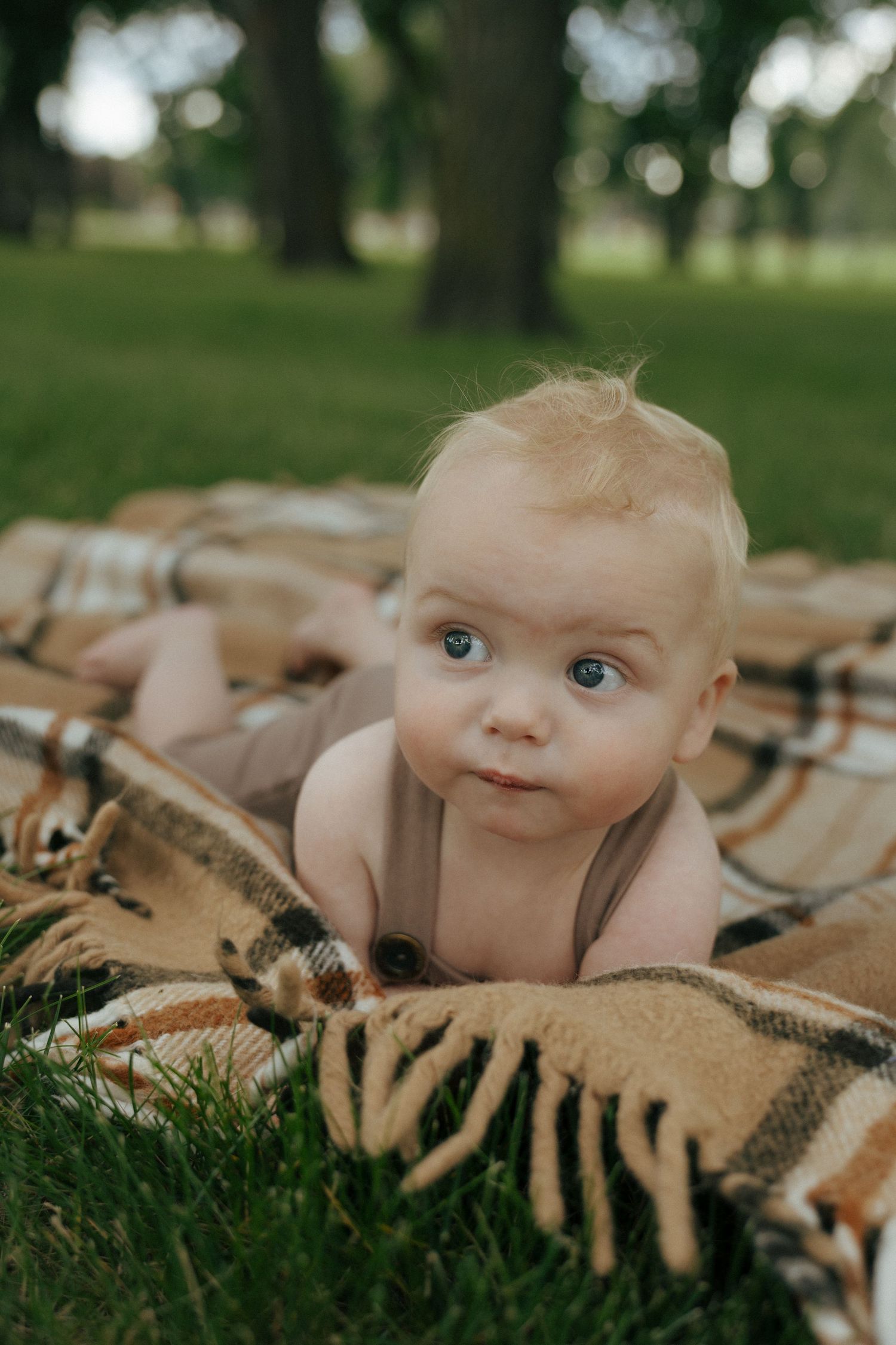 baby laying on blanket on the capitol grounds in Bismarck North Dakota