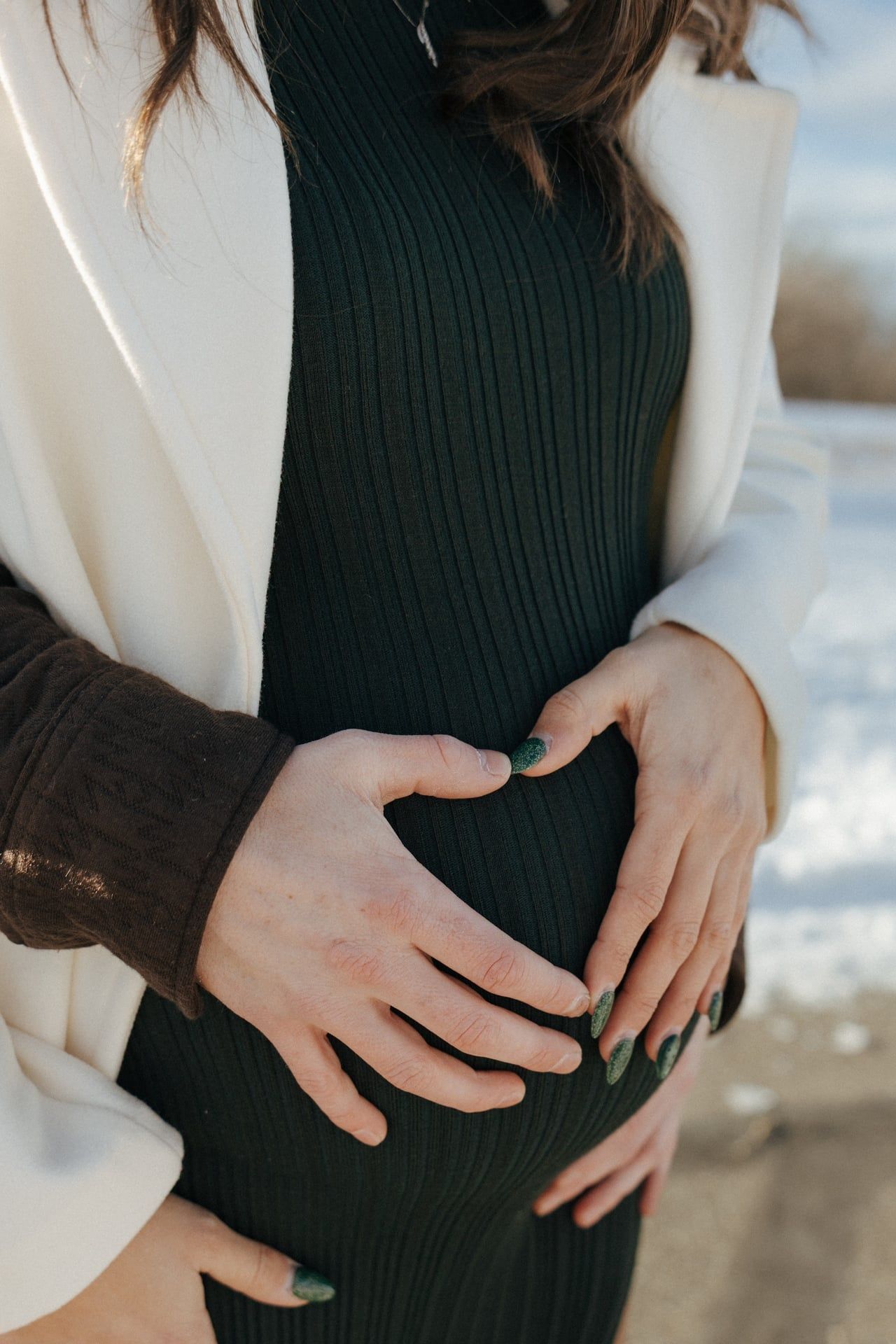 heart on baby bump for maternity session in Bismarck