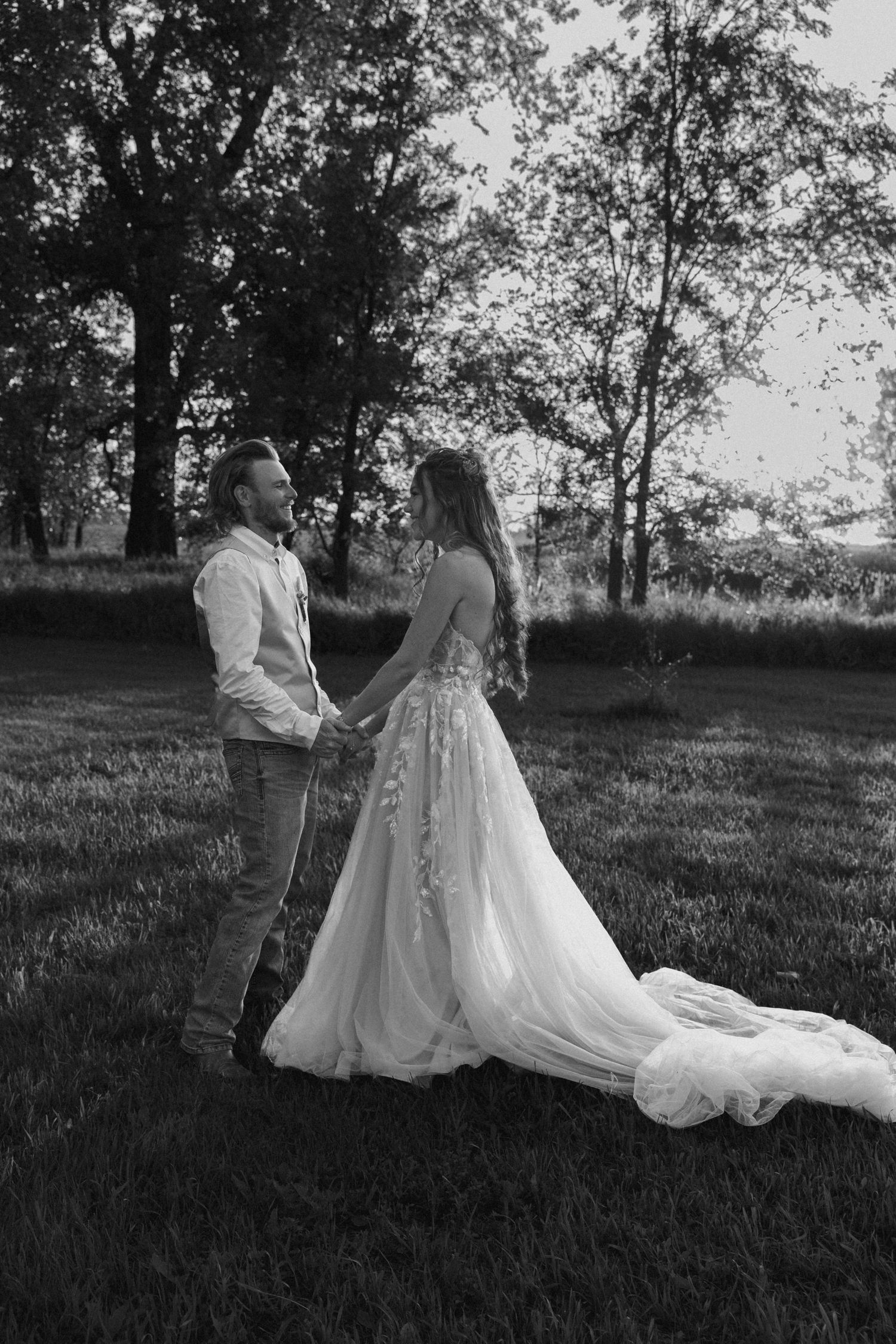 groom and bride holding hands laughing together in Dawson North Dakota