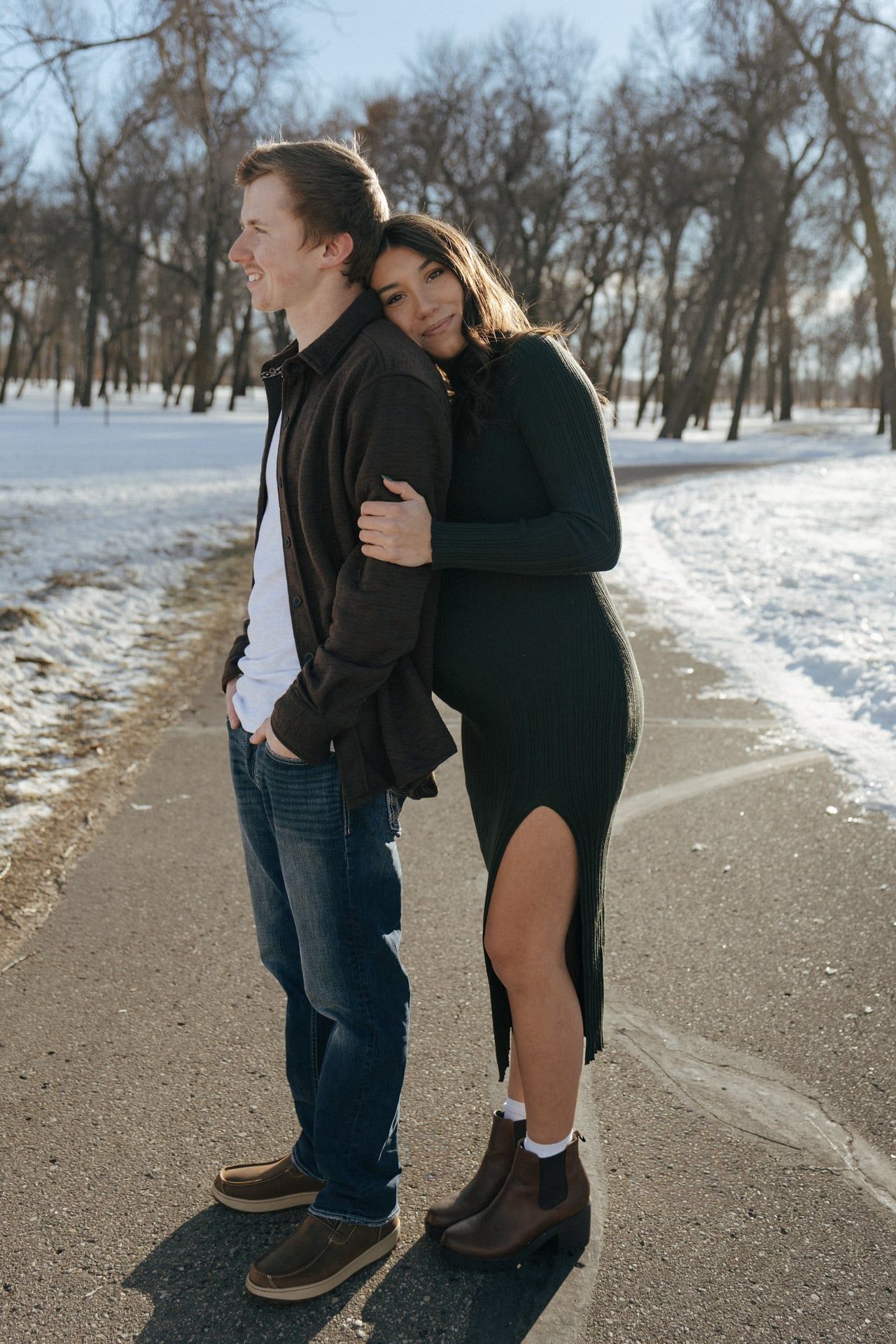 Couple smiling at camera in snowy park in Bismarck