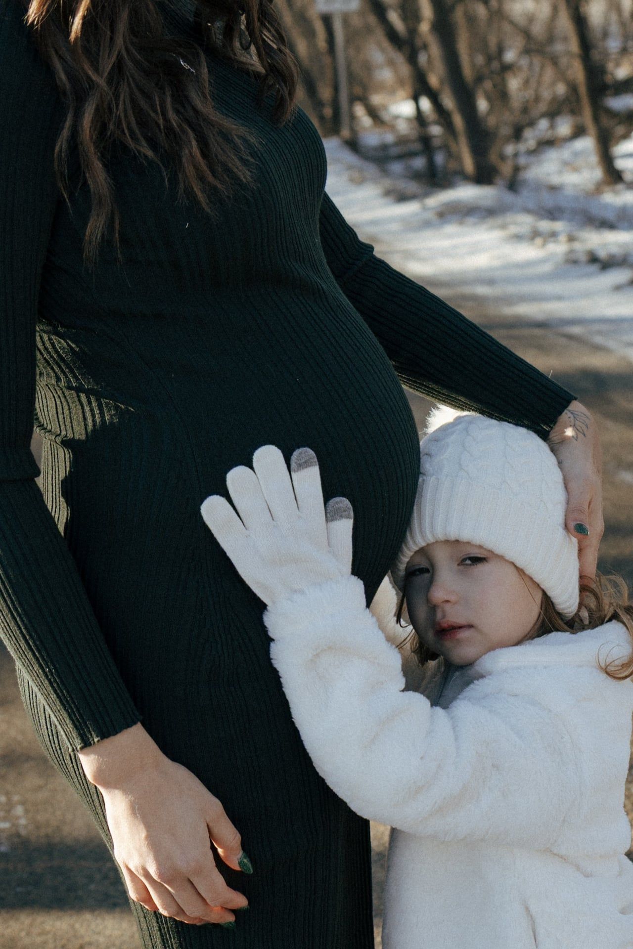 photos of mother to be with daughter in snowy trees in Bismarck
