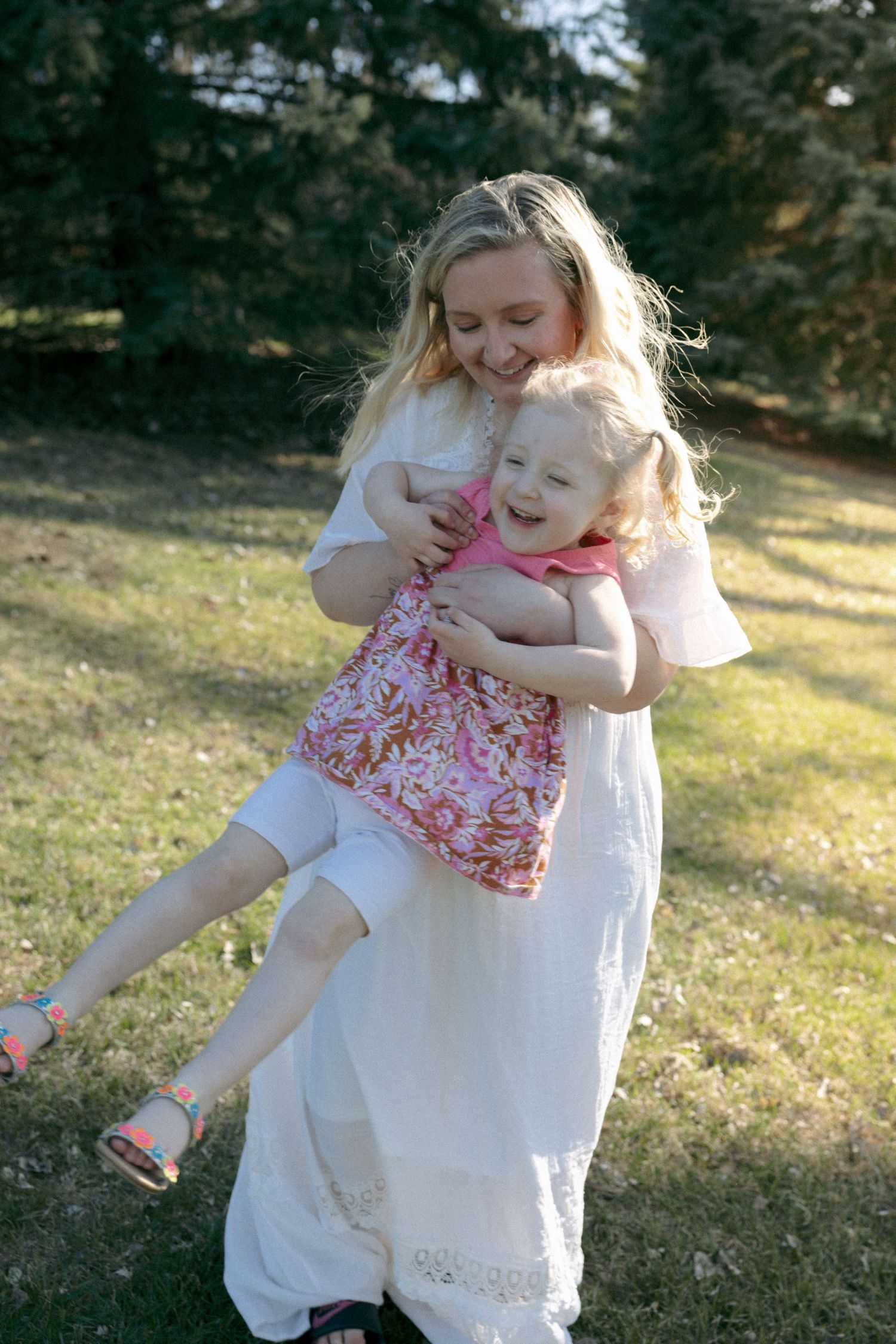 mom playing with daughter as she laughs in Bismarck for mom and me session