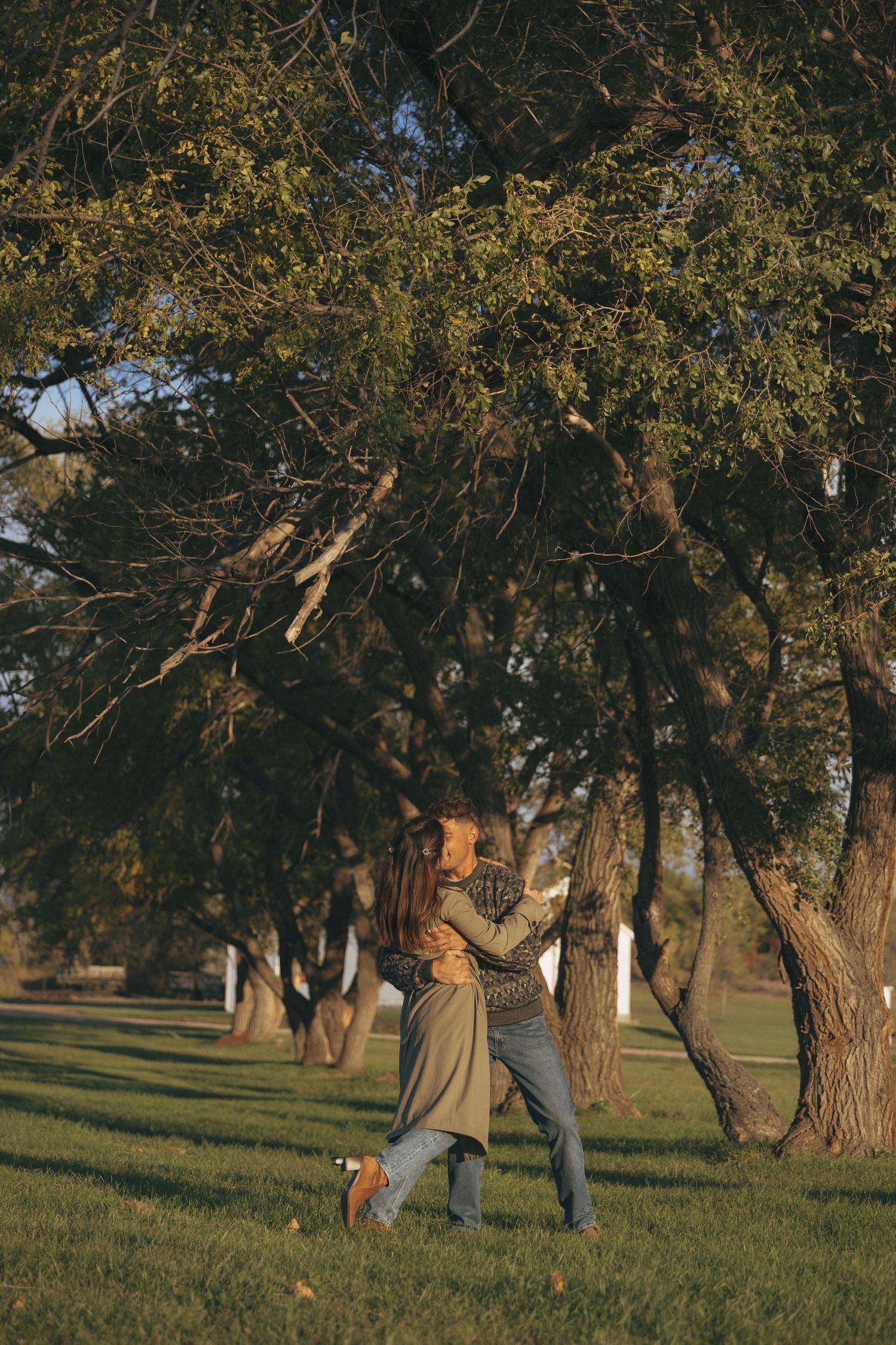 couple embracing in sunset light during engagement session in Bismarck