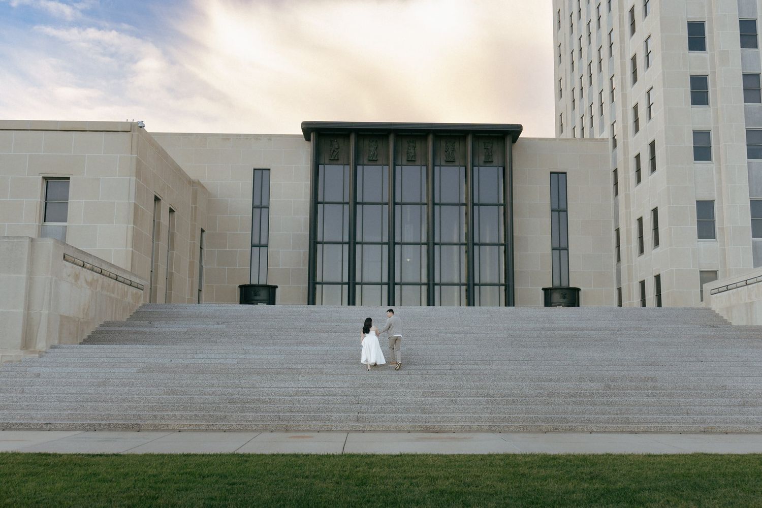 couple walking up Bismarck Capitol Building stairs