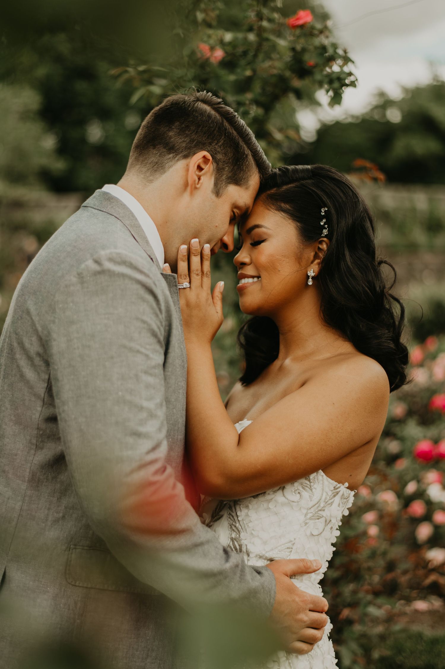 Romantic wedding couple embracing in a rose garden setting in Asheville north carolina.