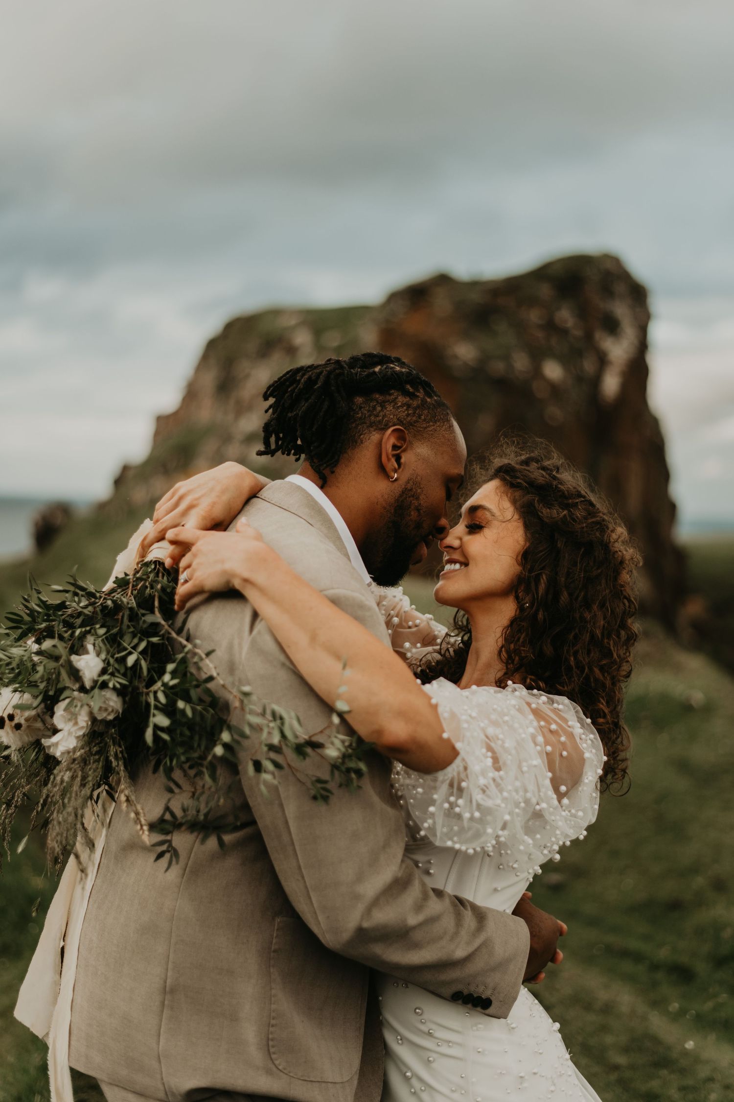 Romantic wedding portraits showing intimate moments against dramatic rocky landscape in isle of skye Scotland.