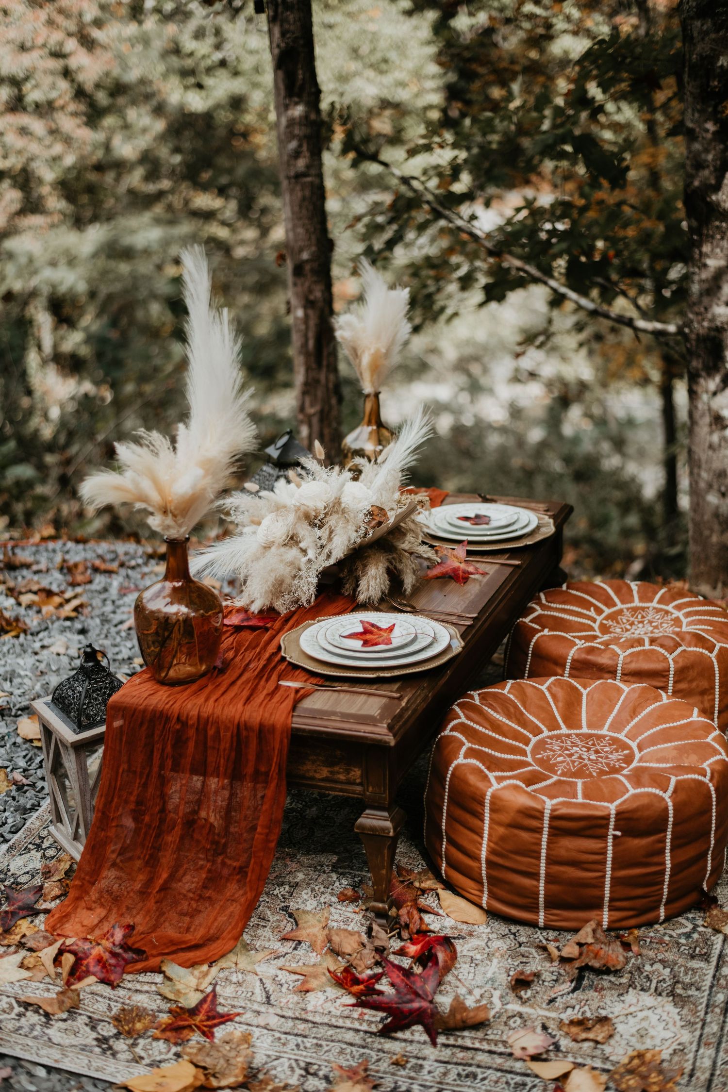 Rustic wedding table setting with terracotta linens and dried floral arrangements.