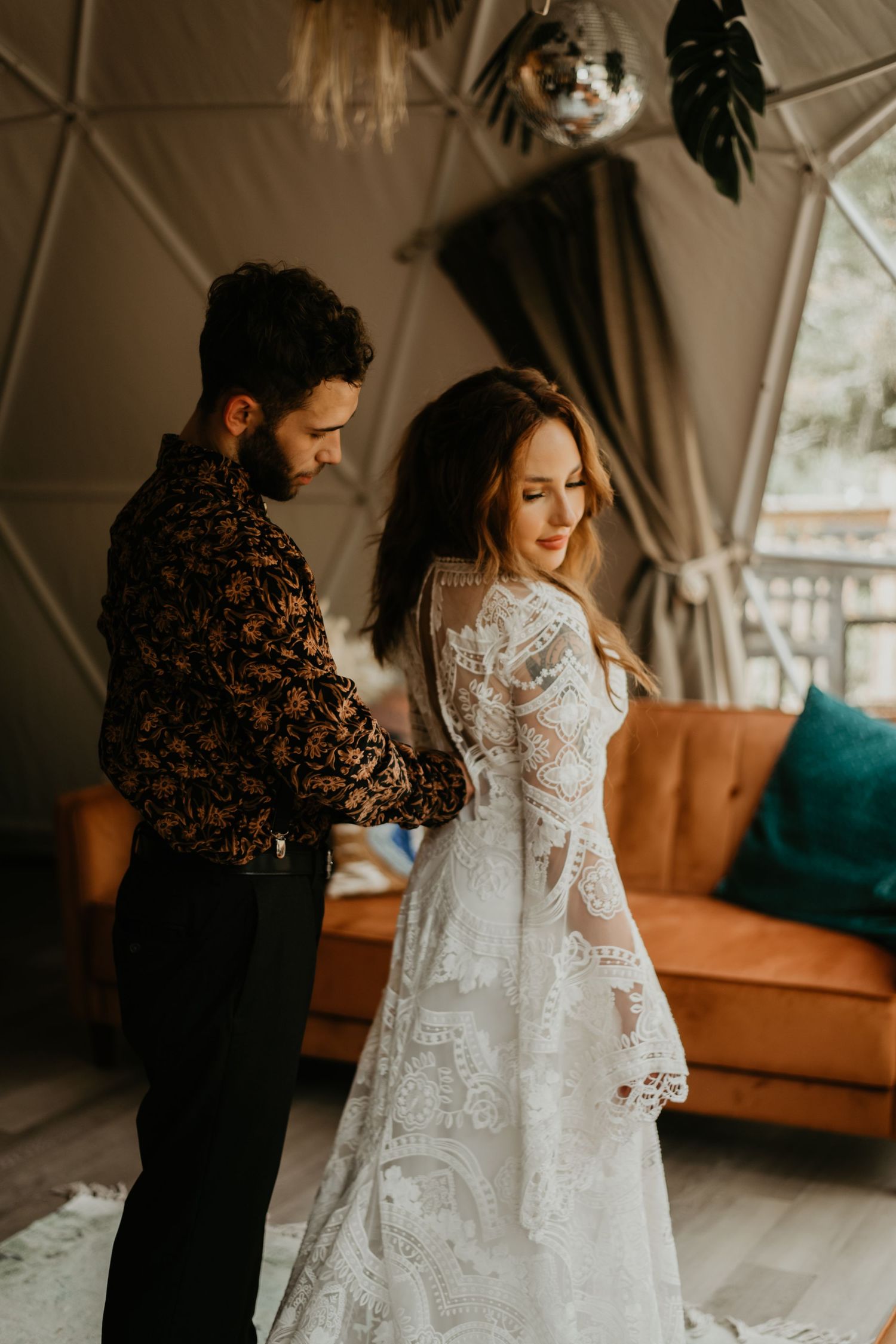 Couple shares intimate first look moment in elegantly decorated indoor space with romantic lighting in Tennessee.