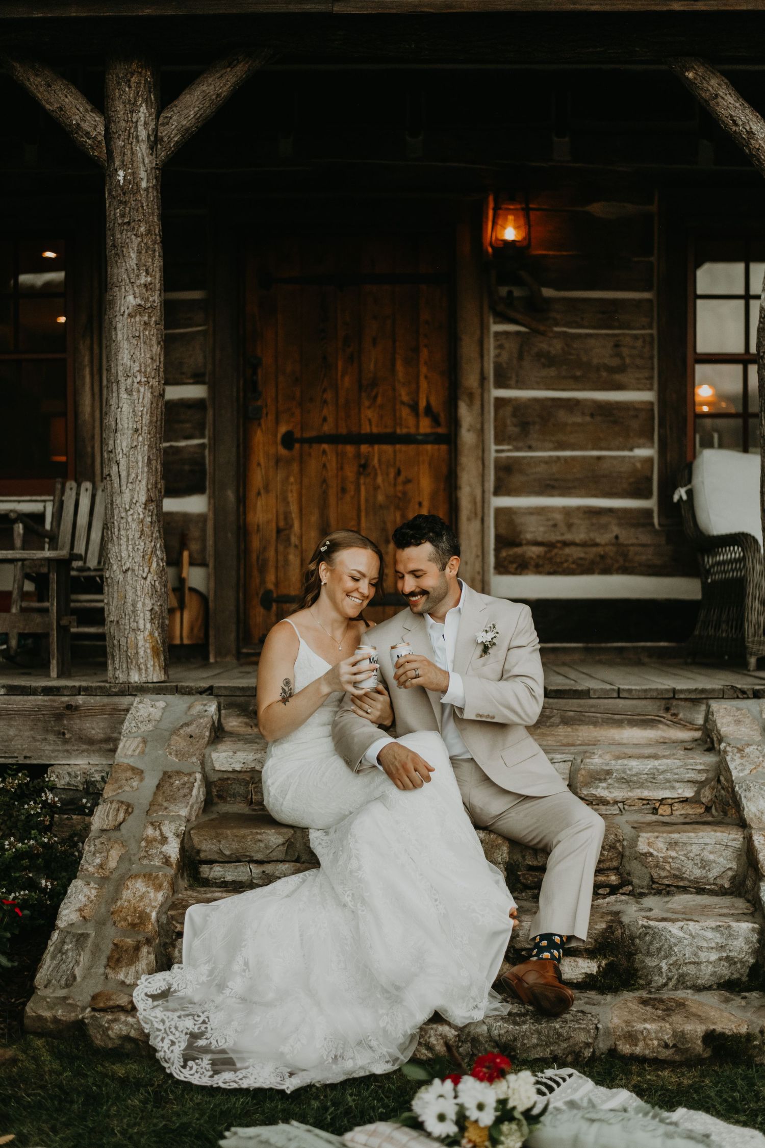 Couple sits on rustic cabin porch steps during intimate wedding moment in Italy.