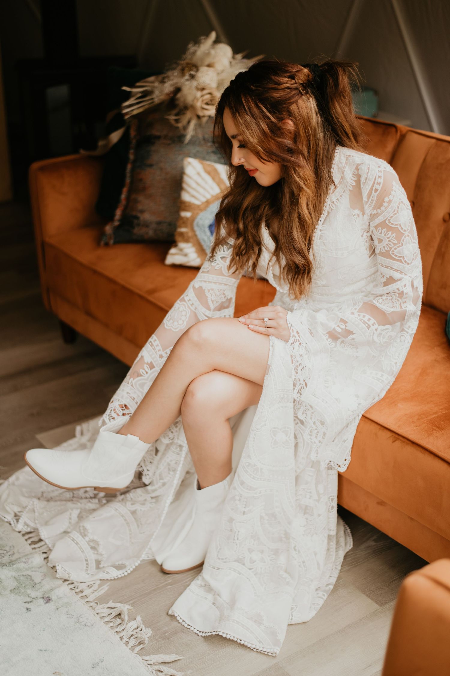 Elegant white lace wedding dress detail with textured fabric and flowing skirt.
