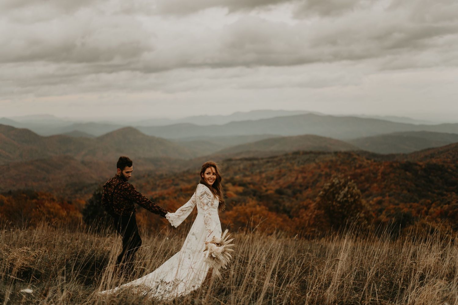 Panoramic mountain vista creates stunning backdrop for romantic wedding photography in north Carolina.