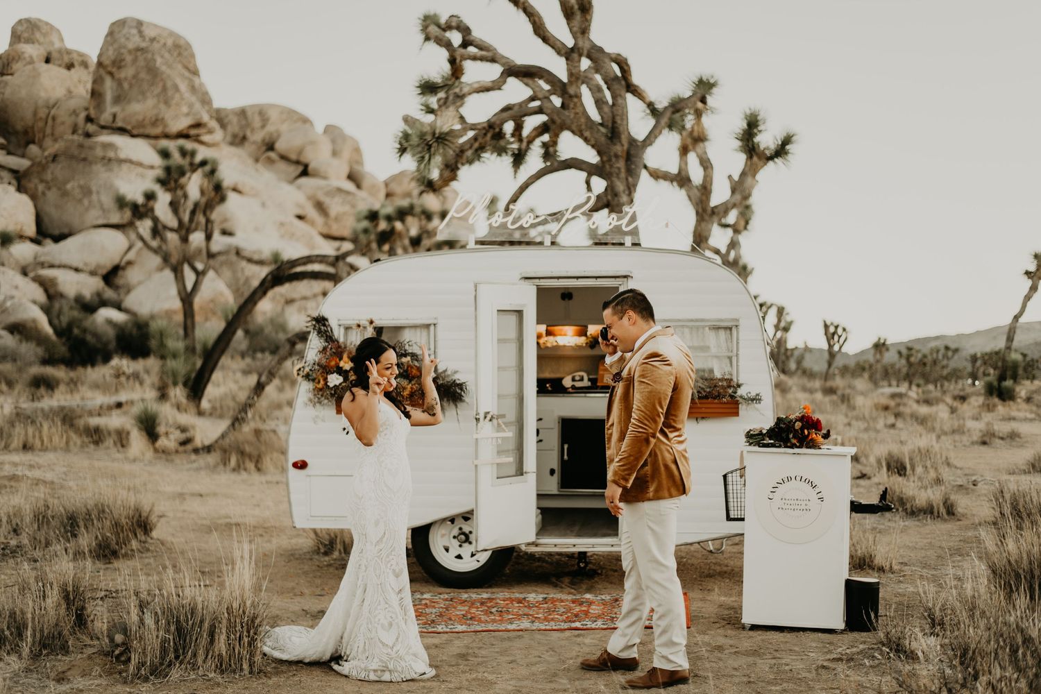 A desert wedding photoshoot with a vintage Airstream trailer and Joshua trees in the background.
