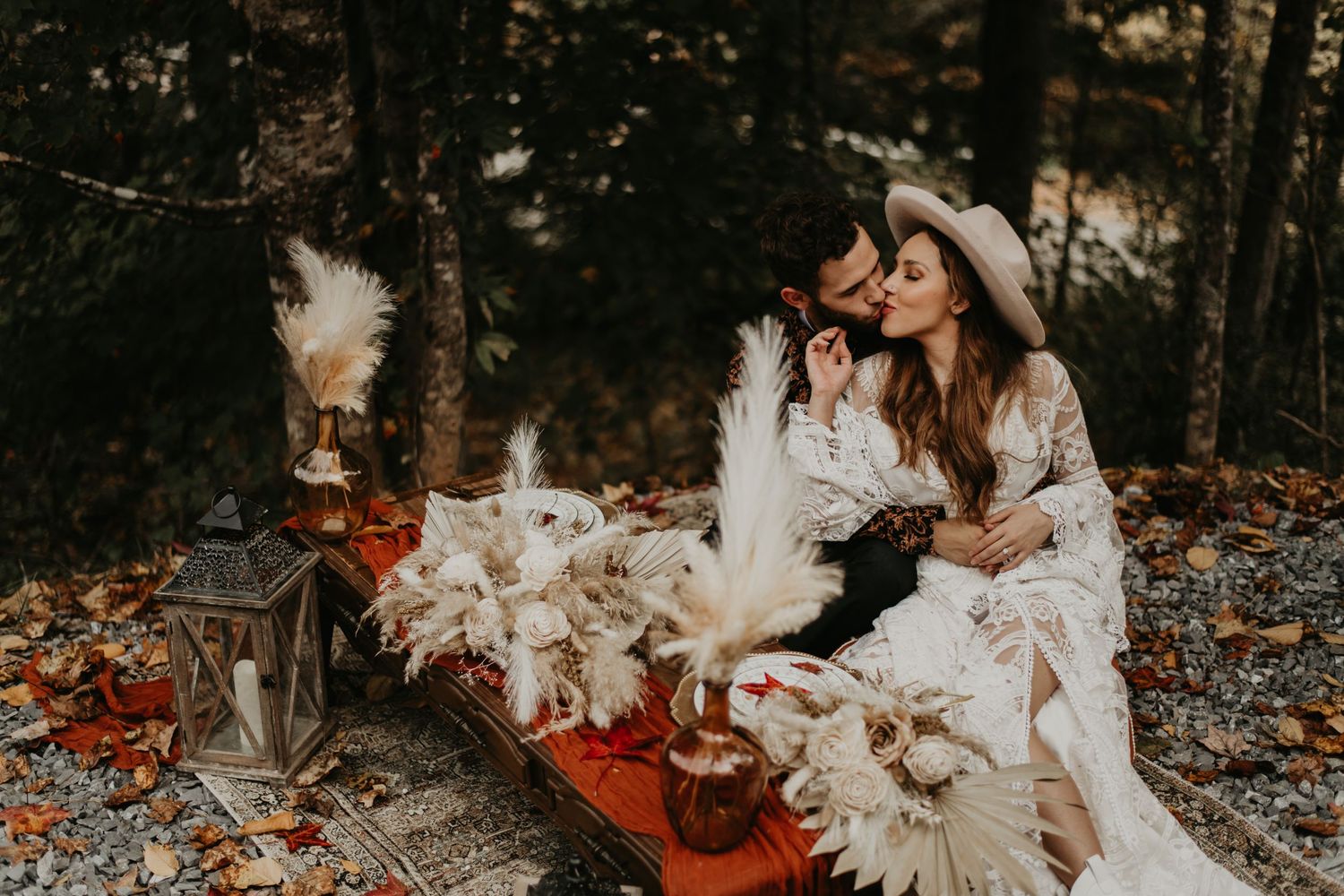 Romantic couples photoshoot with white lace dress and clear umbrellas in an autumn forest setting.