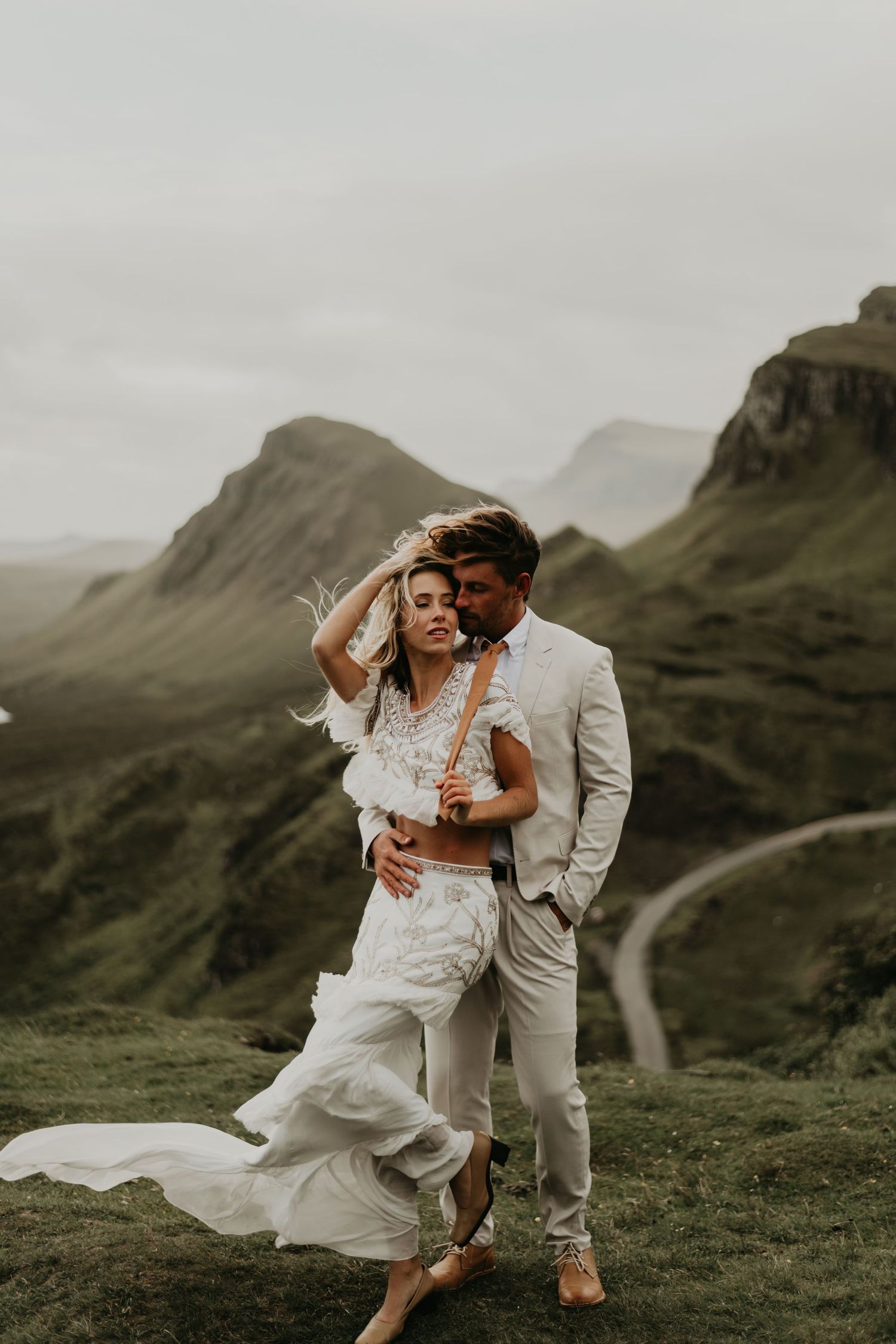 Intimate wedding portraits on scenic mountain cliffs with dramatic landscape views in isle of skye Scotland.