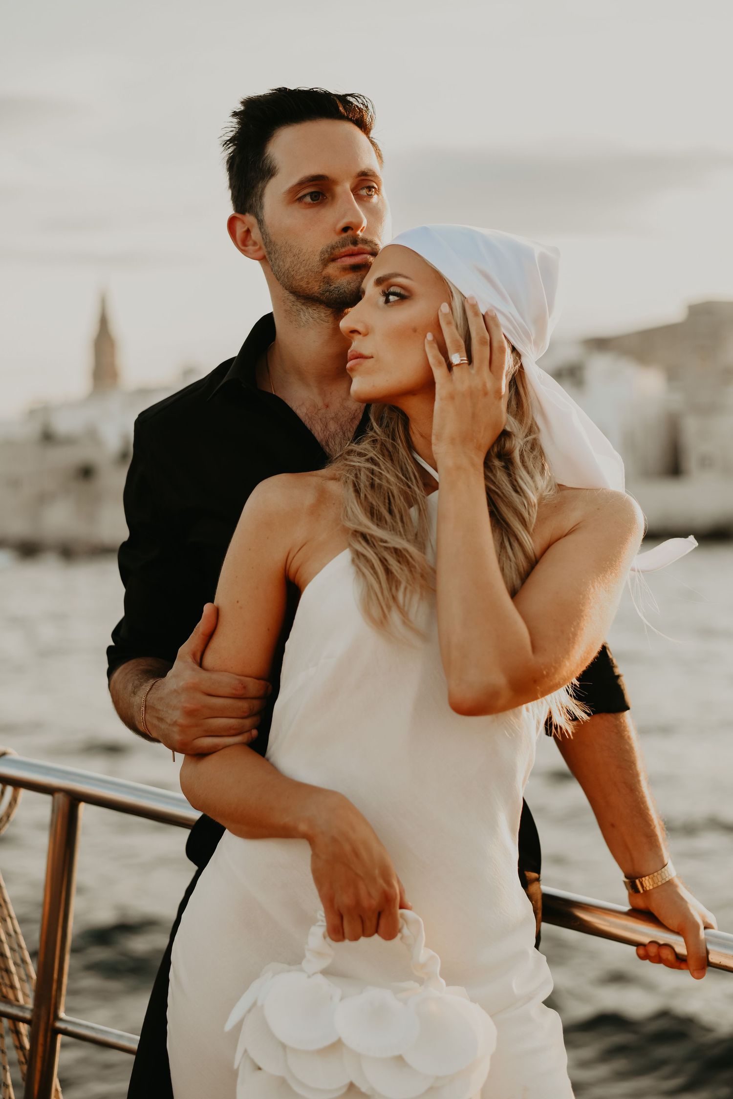 Intimate seaside wedding photos capture couple's romantic embrace at sunset in Monopoli Italy.