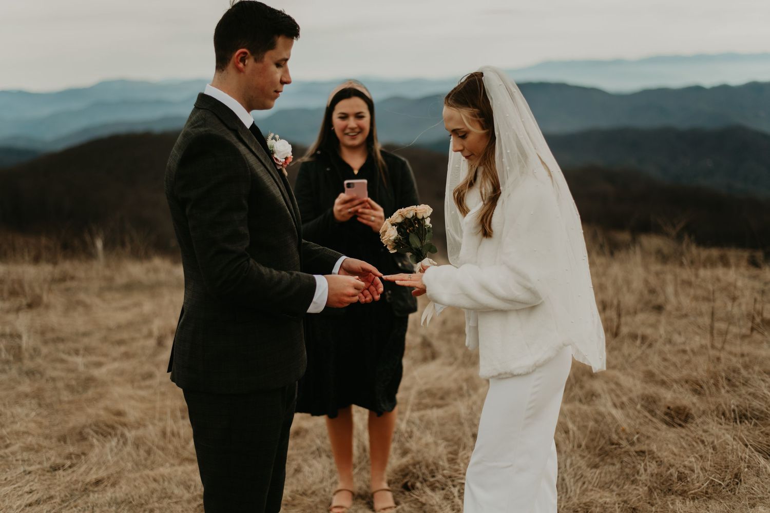 Intimate outdoor wedding ceremony set against a mountainous landscape backdrop in North Carolina.