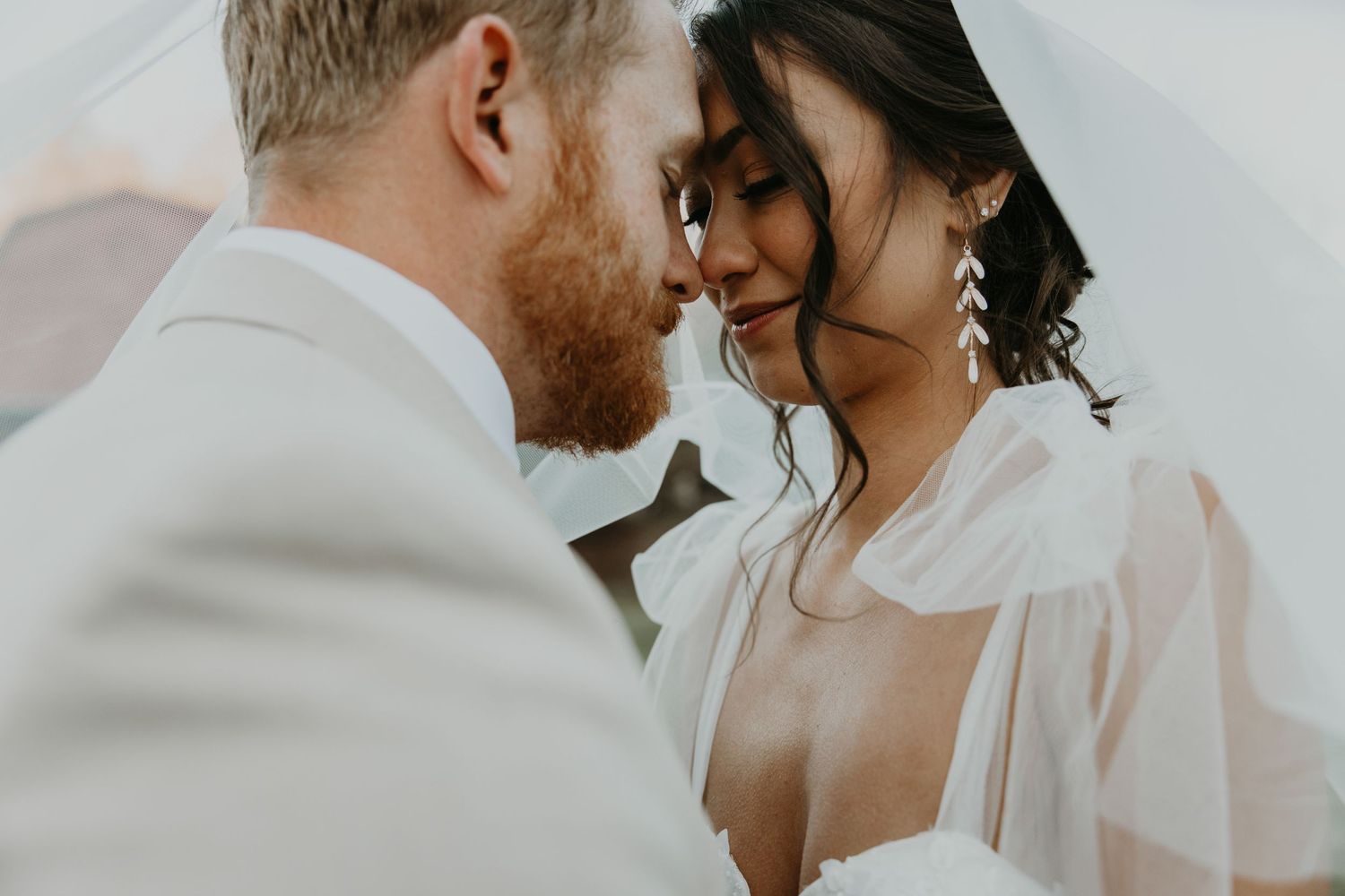Intimate close-up of newlyweds sharing romantic moment.