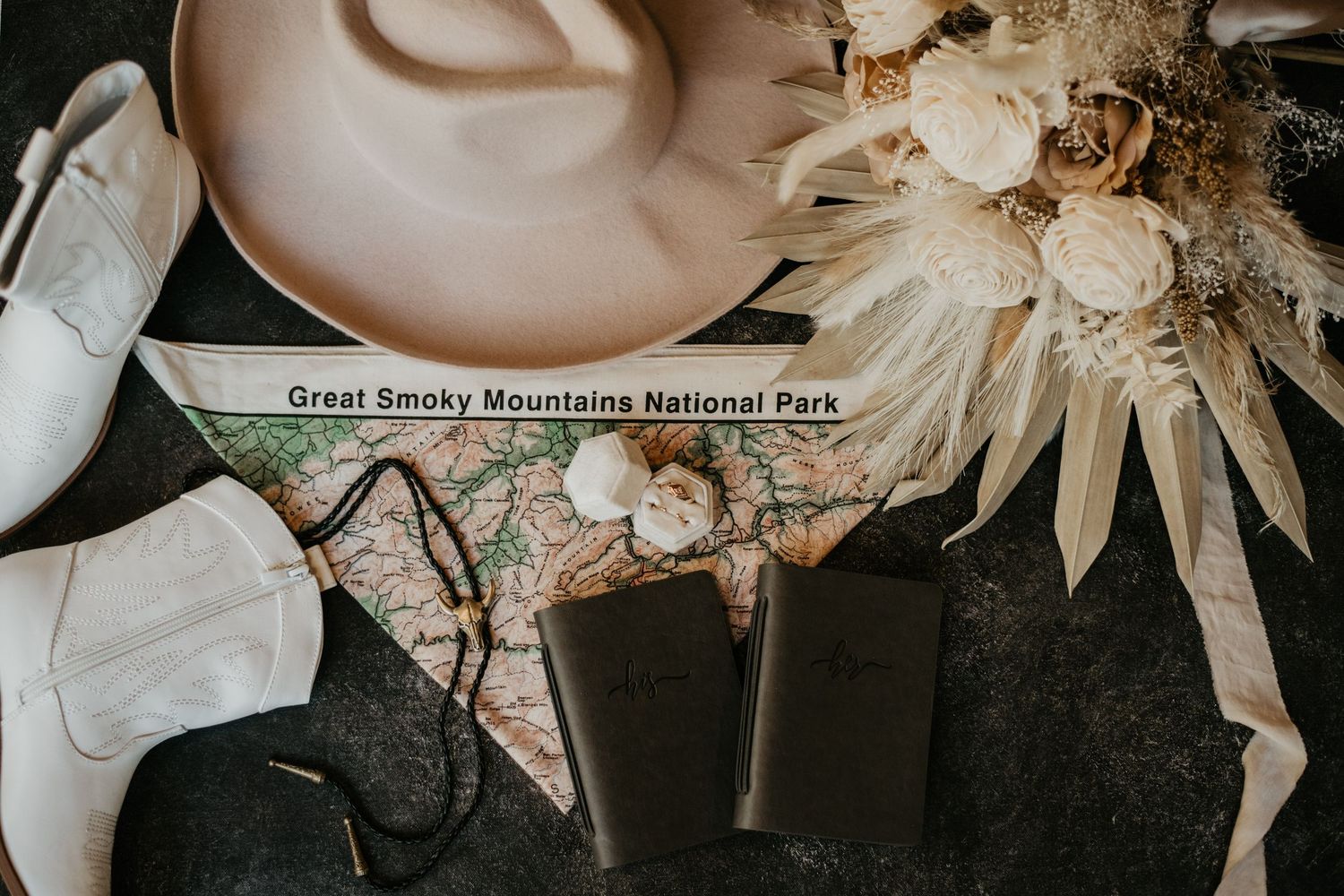 Floral wedding decor featuring dried flowers and Great Smoky Mountains National Park signage.