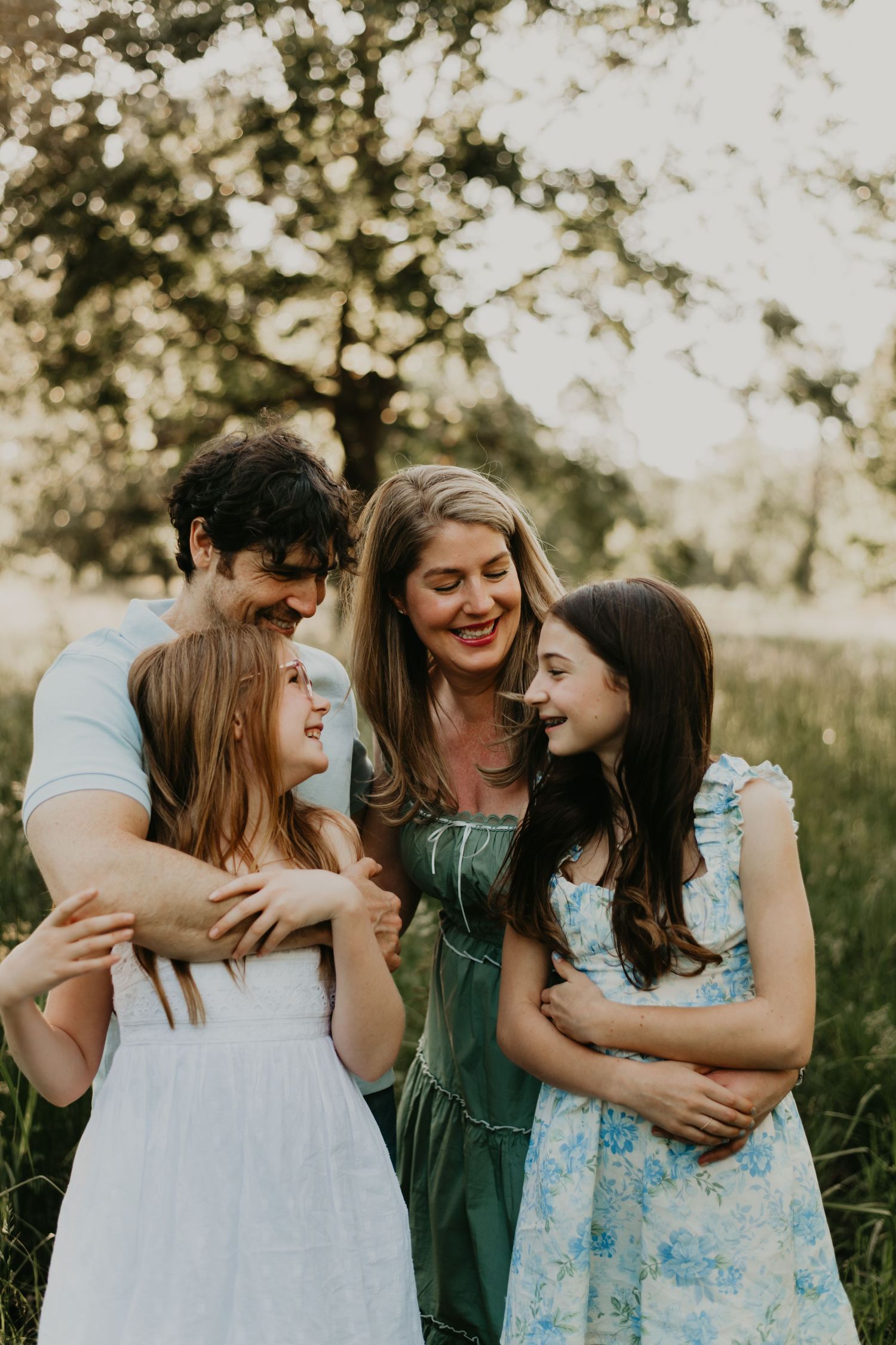 Group sharing joyful laughter together in golden evening sunlight in Asheville North Carolina