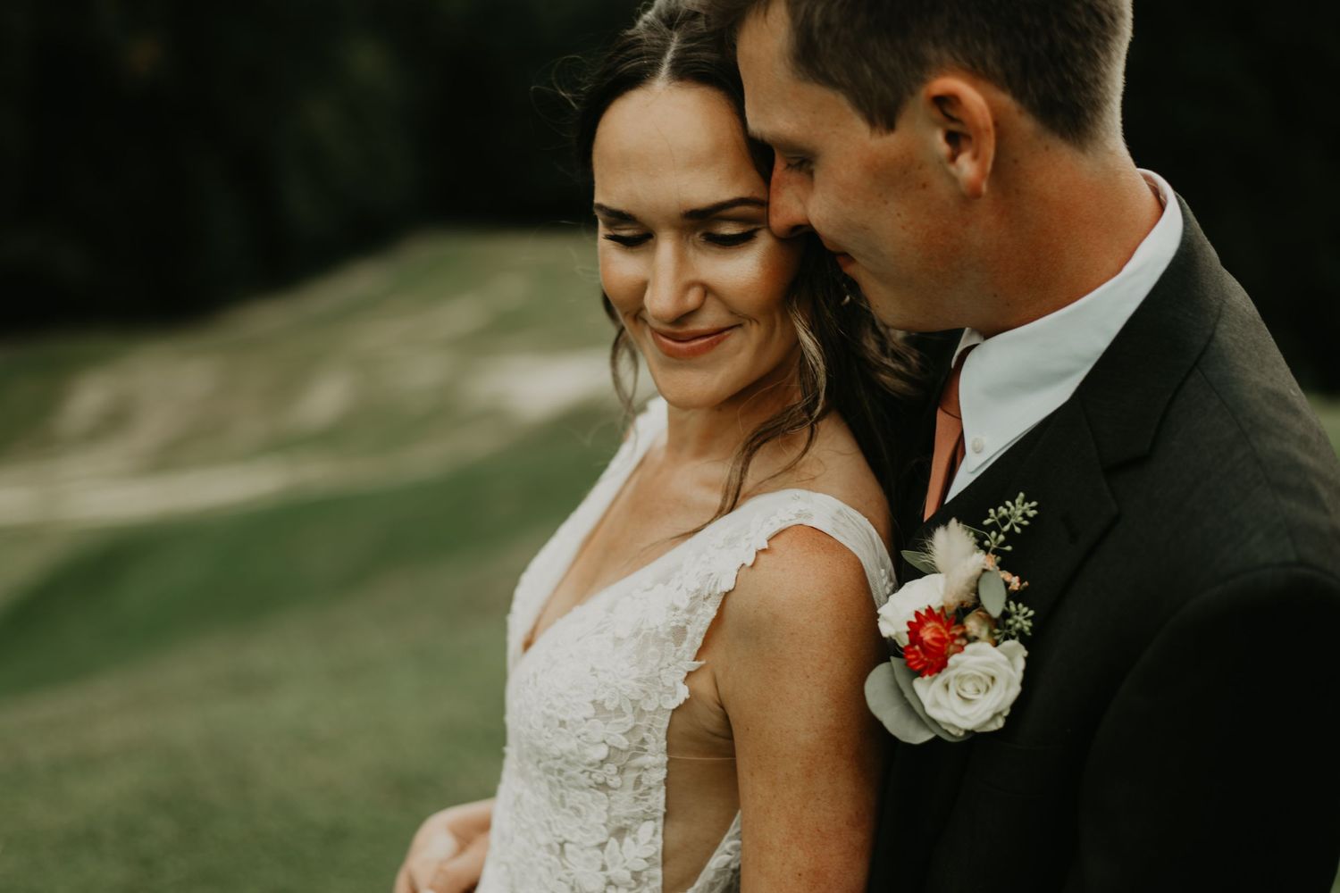 Elegant wedding couple shares intimate moment during outdoor photo session in Asheville North Carolina.