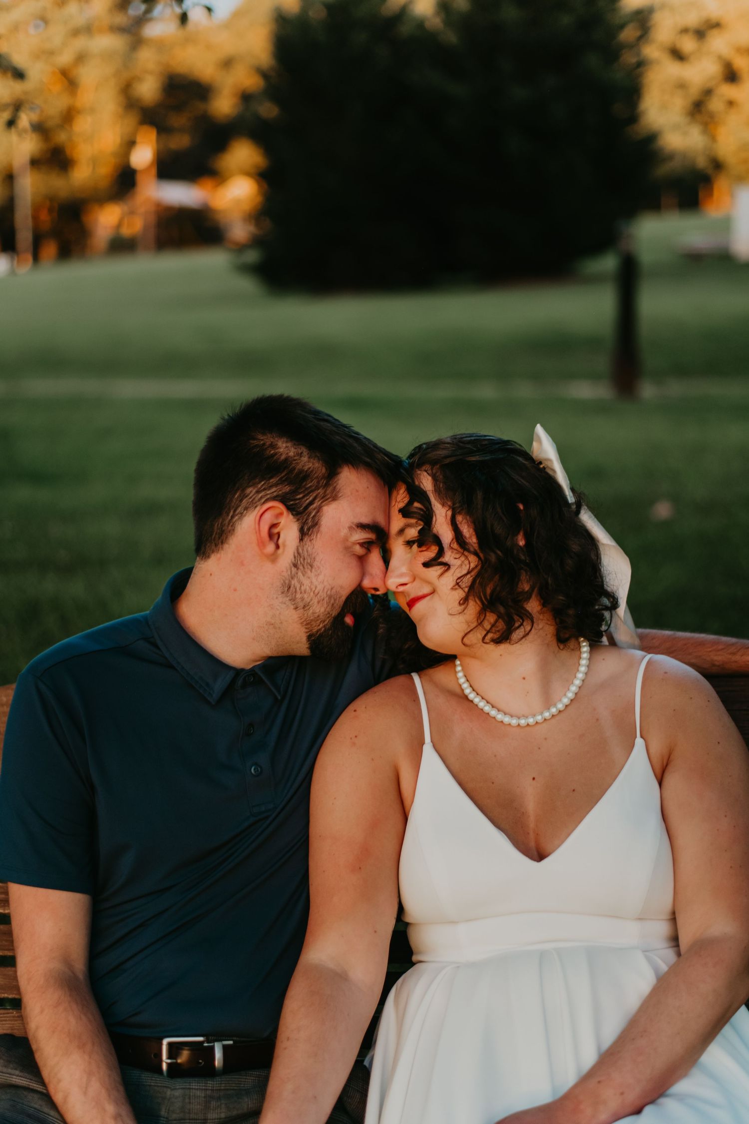 A sequence of romantic photos showing a couple sharing intimate moments at sunset in a park setting.