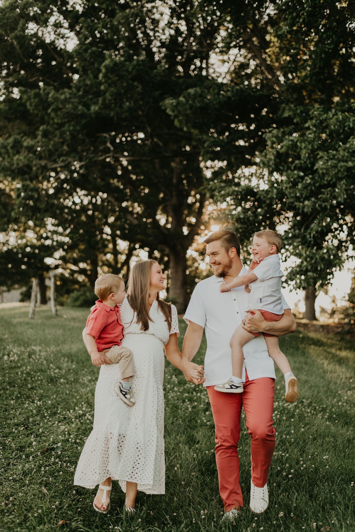 Family enjoying tender outdoor moment together in sunny park setting in Asheville North Carolina