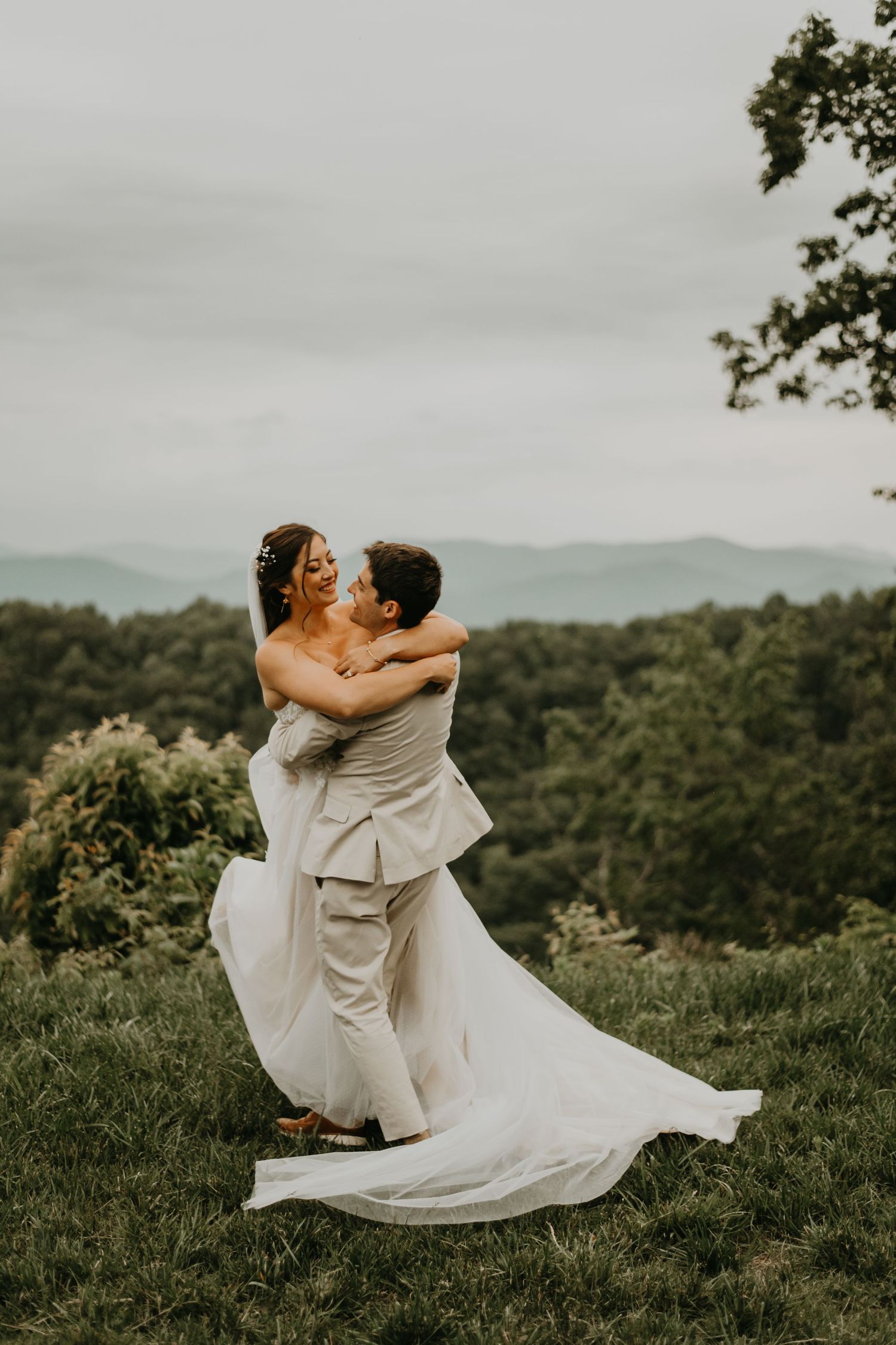 A romantic wedding dance captured on a hilltop with mountains in the background in north Carolina.