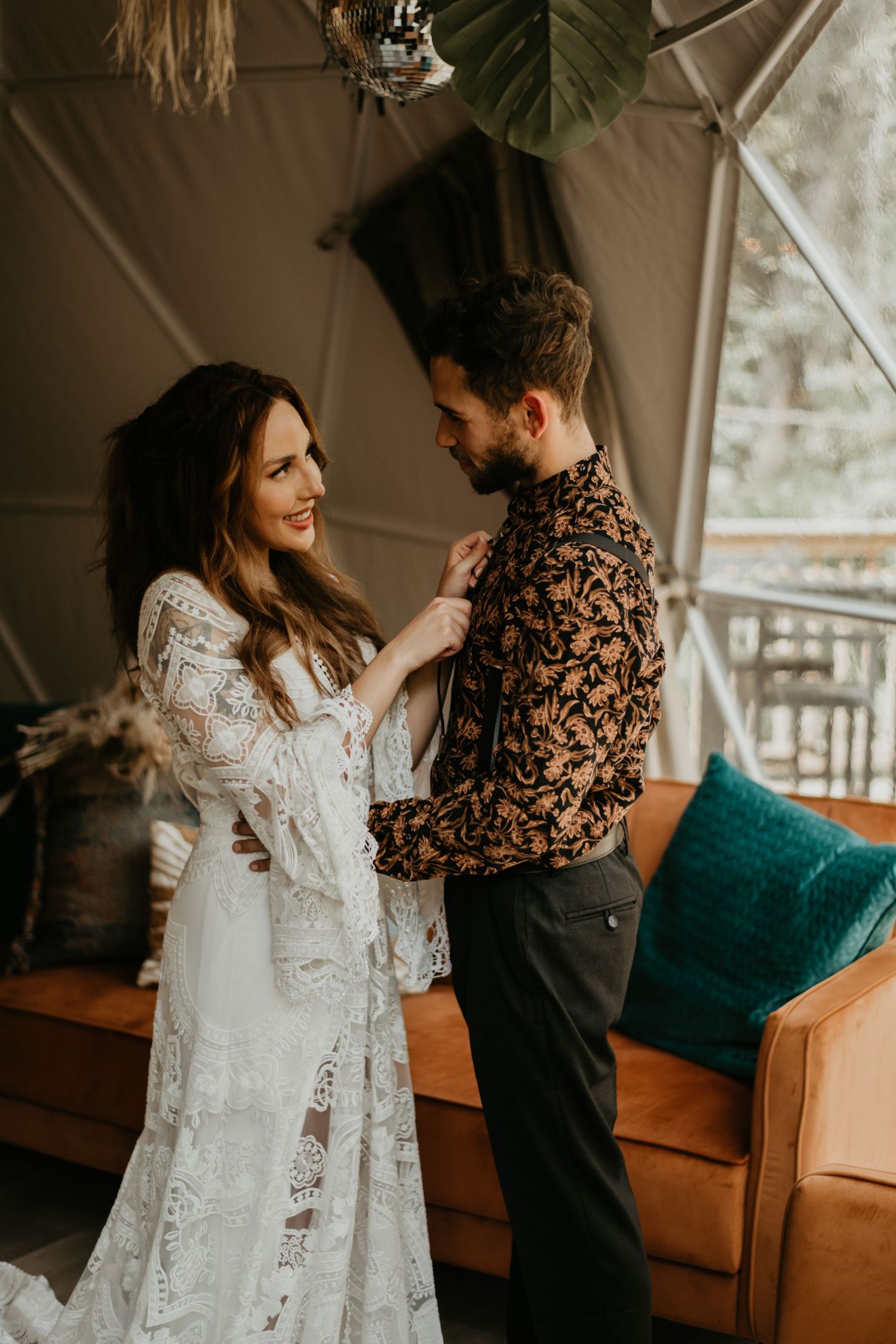 Intimate indoor portrait with lace wedding dress and boho decor.