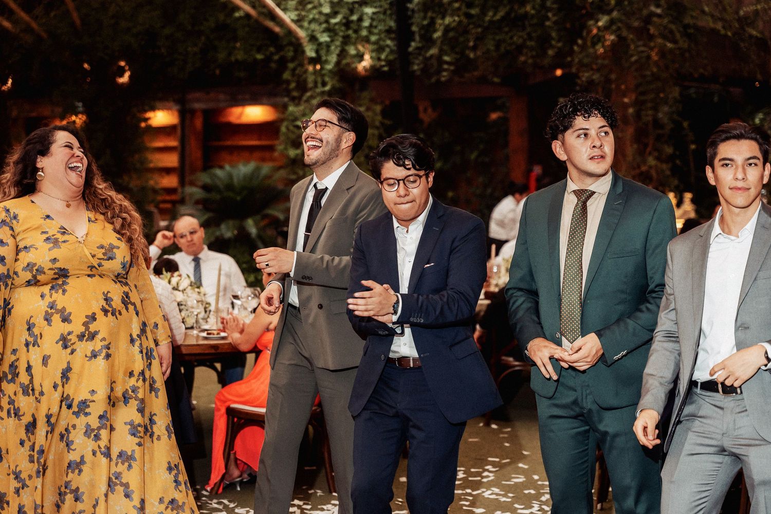 Wedding reception party with guests in formal attire mingling and celebrating.