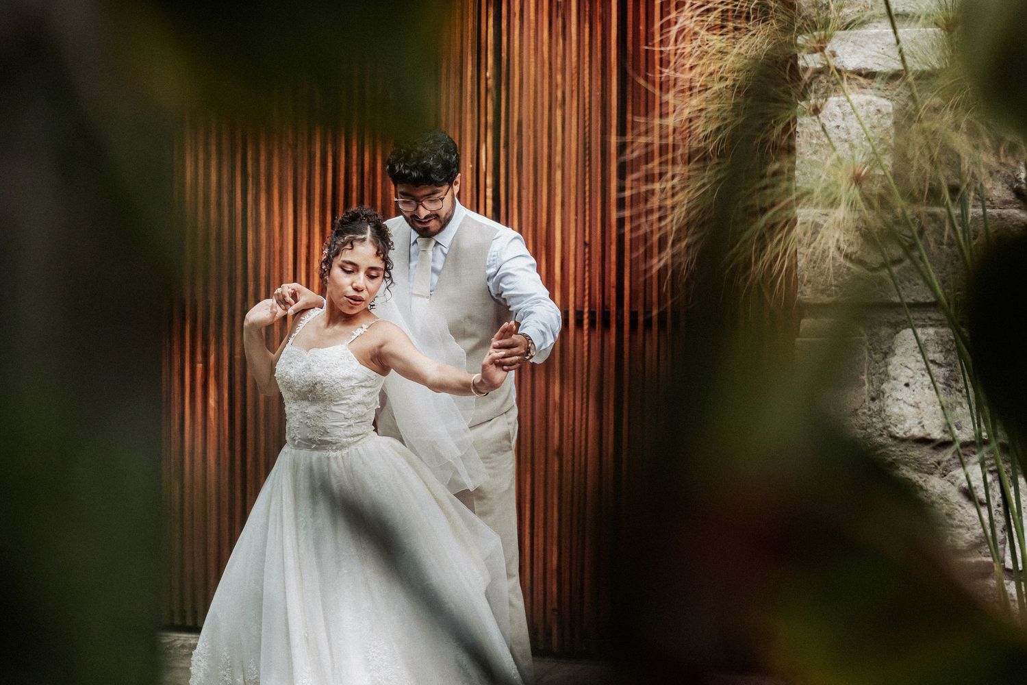 Wedding portraits captured against a wooden backdrop showing tender moments between the newlyweds.