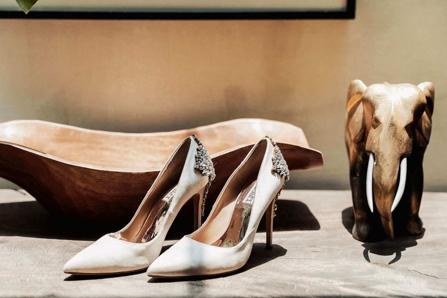 A collection of elegant women's dress shoes in neutral colors displayed against a soft beige background.