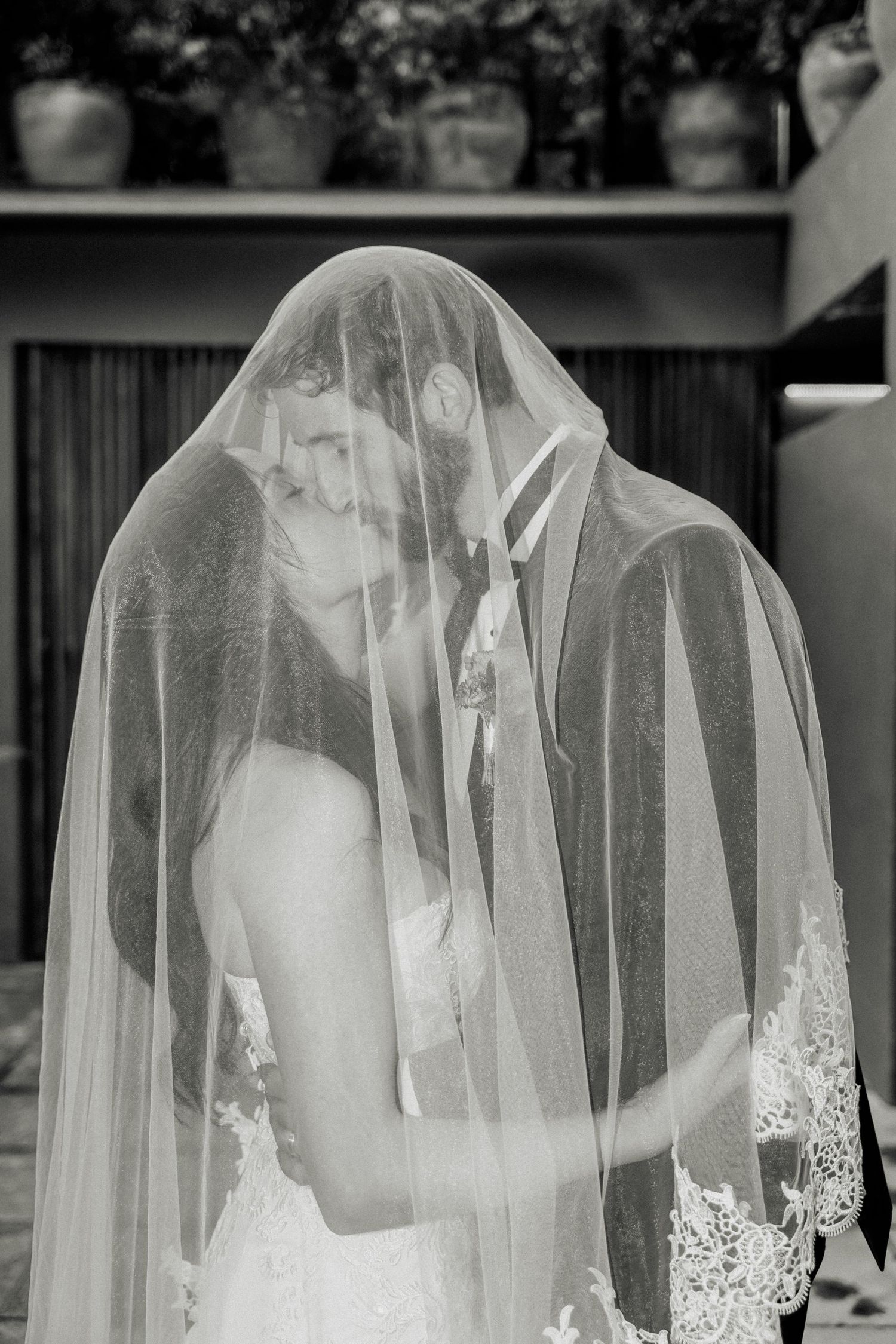 Collection of close-up shots showing delicate lace details on a white wedding veil against a dark background.