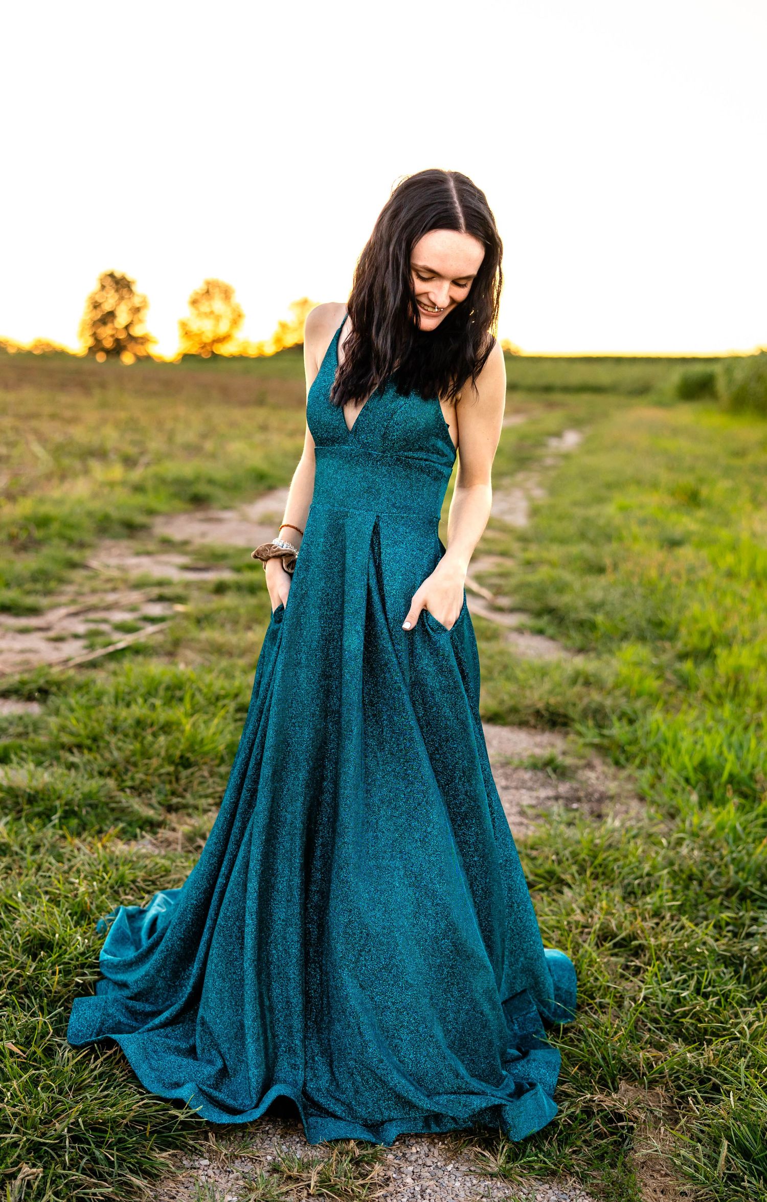 Full-length formal portrait in sparkling teal gown during golden hour.
