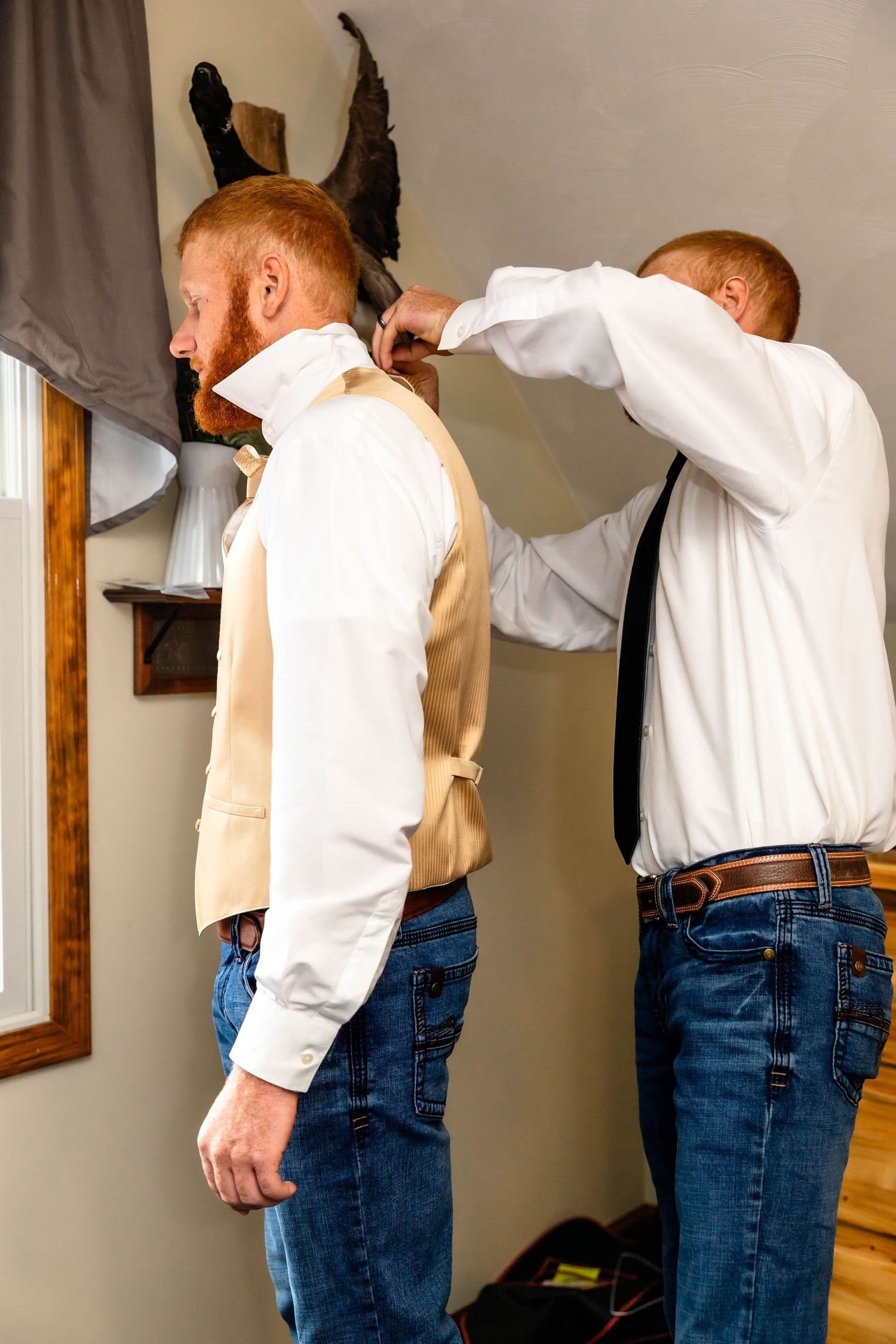 Formal dressing preparation scene with champagne colored vest and white shirt.