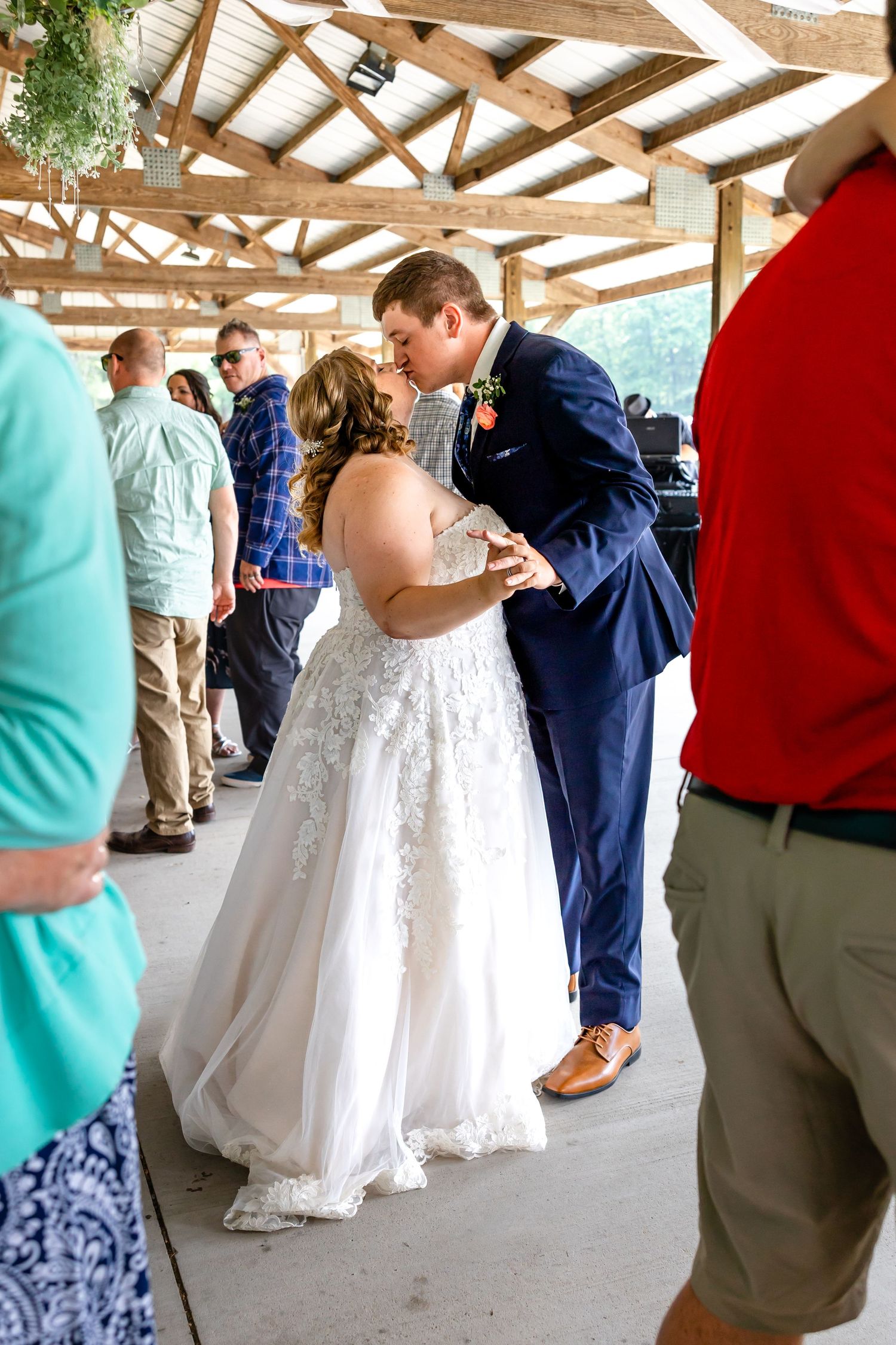 Newlyweds share an intimate dance moment surrounded by wedding guests.