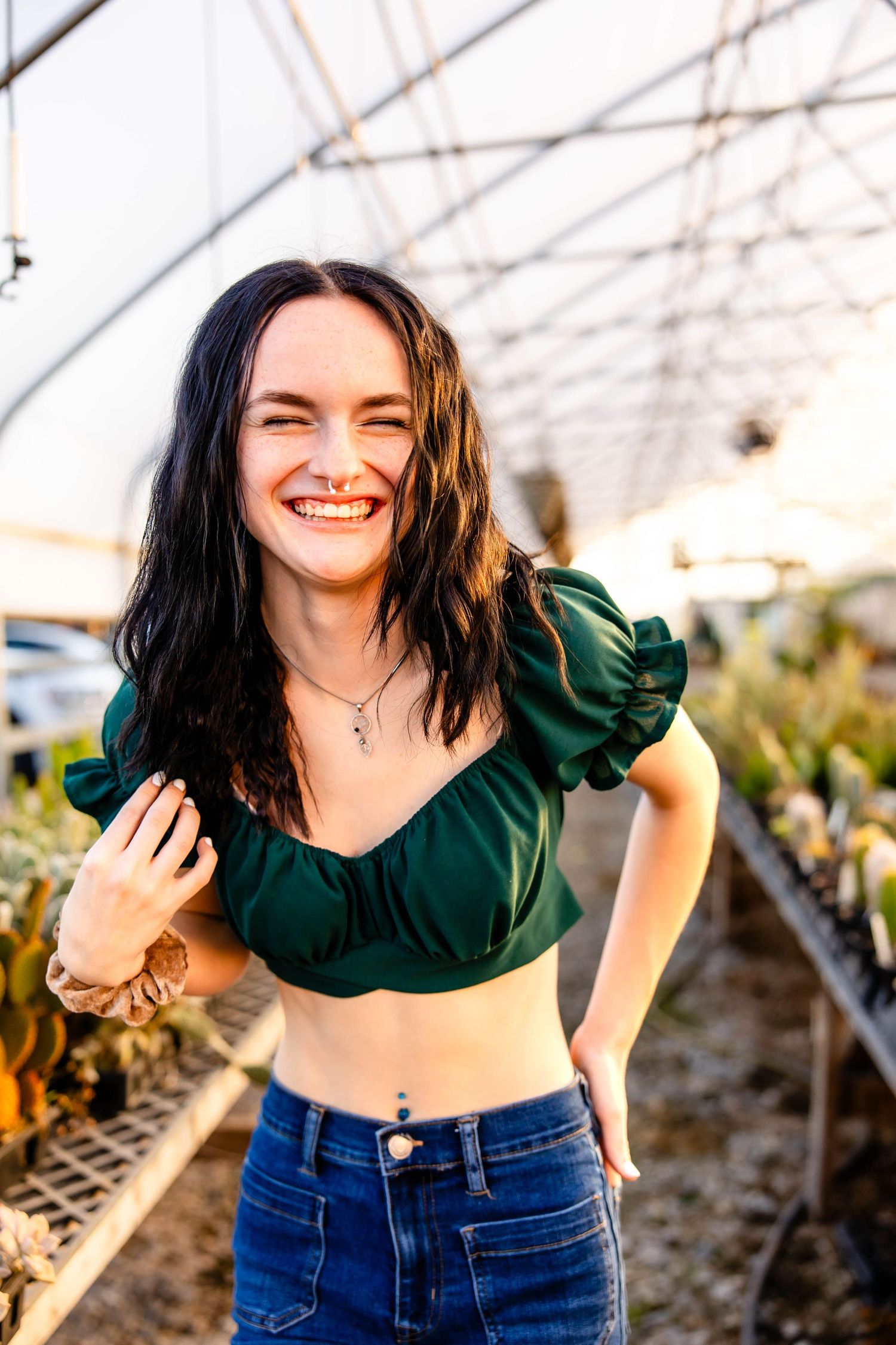 Candid greenhouse photoshoot with casual summer fashion and warm lighting.
