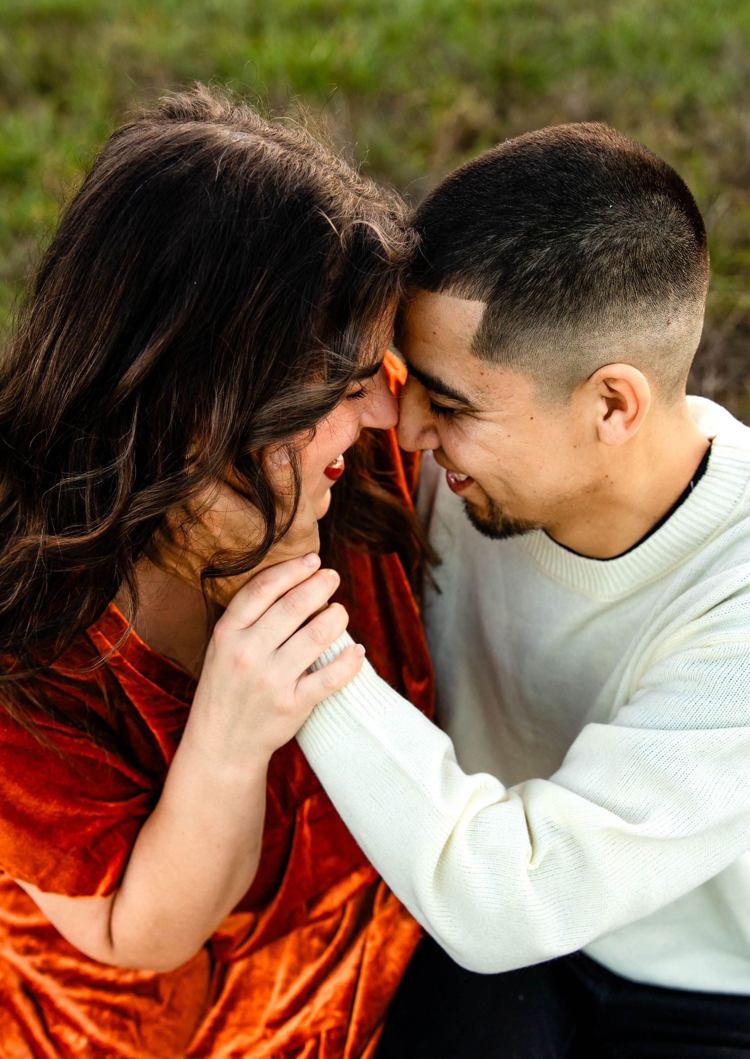Intimate close-up of couple sharing tender moment at sunset.
