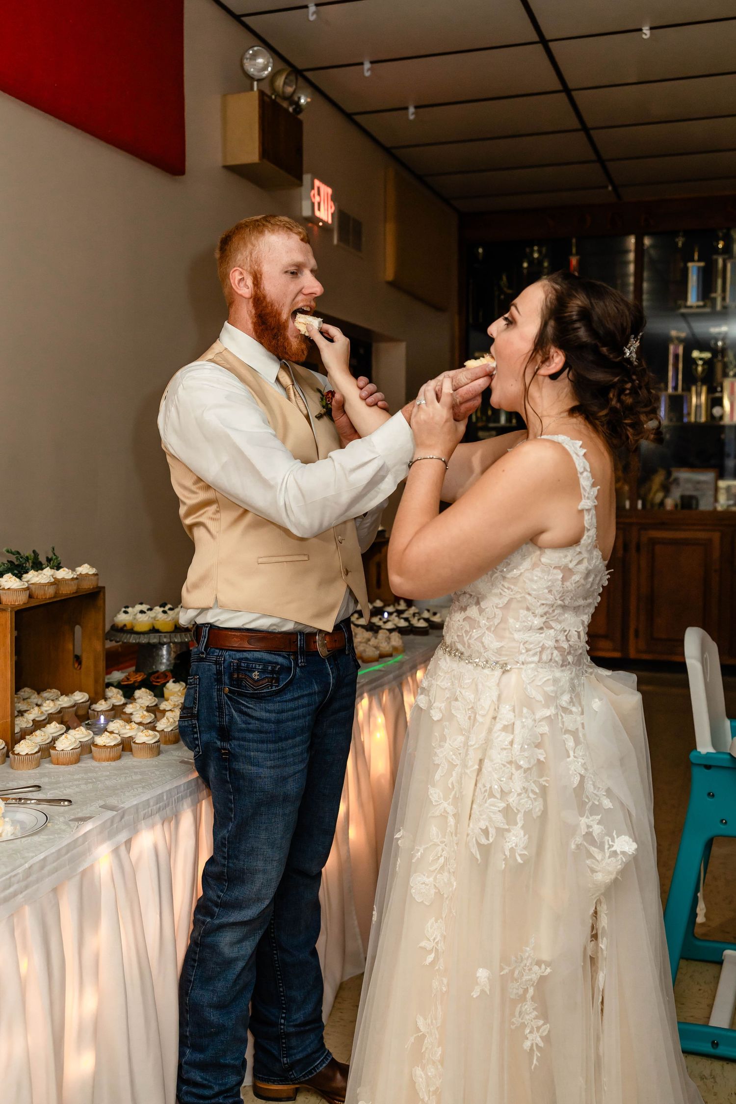 A fun cake feeding tradition moment captured during the wedding reception celebrations.