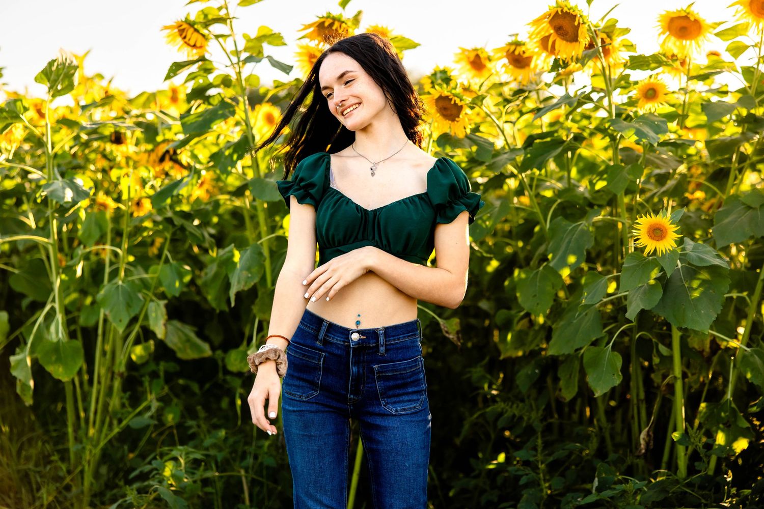 Carefree summer moment captured in a sunflower field with casual fashion.