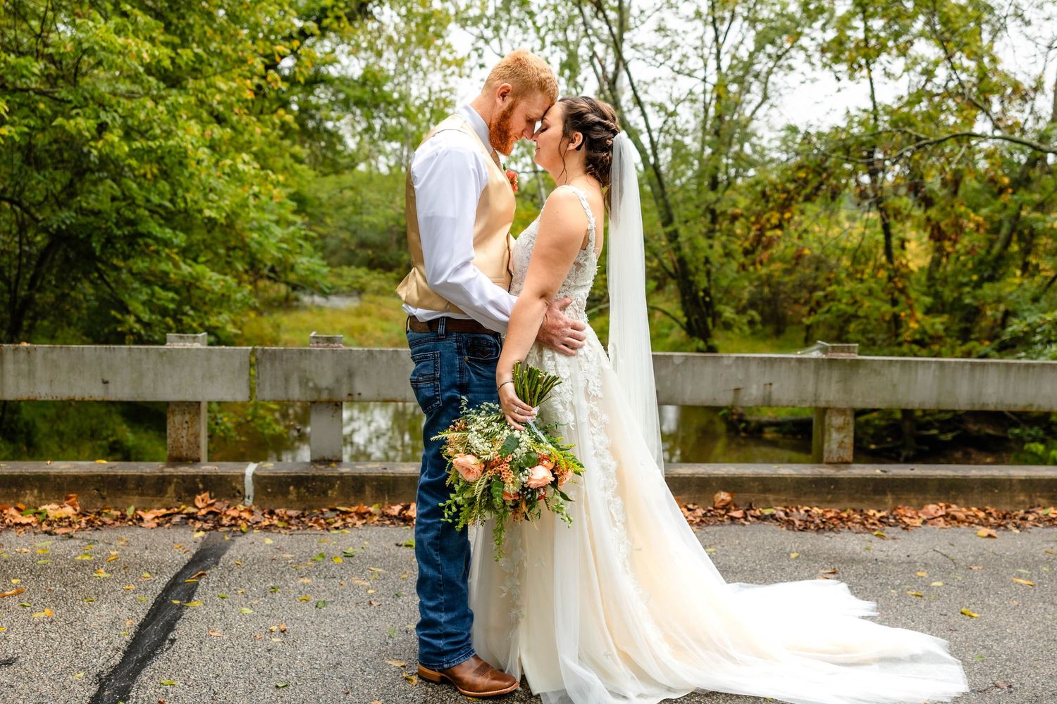 A bride and groom share an intimate moment during an autumn wedding celebration.