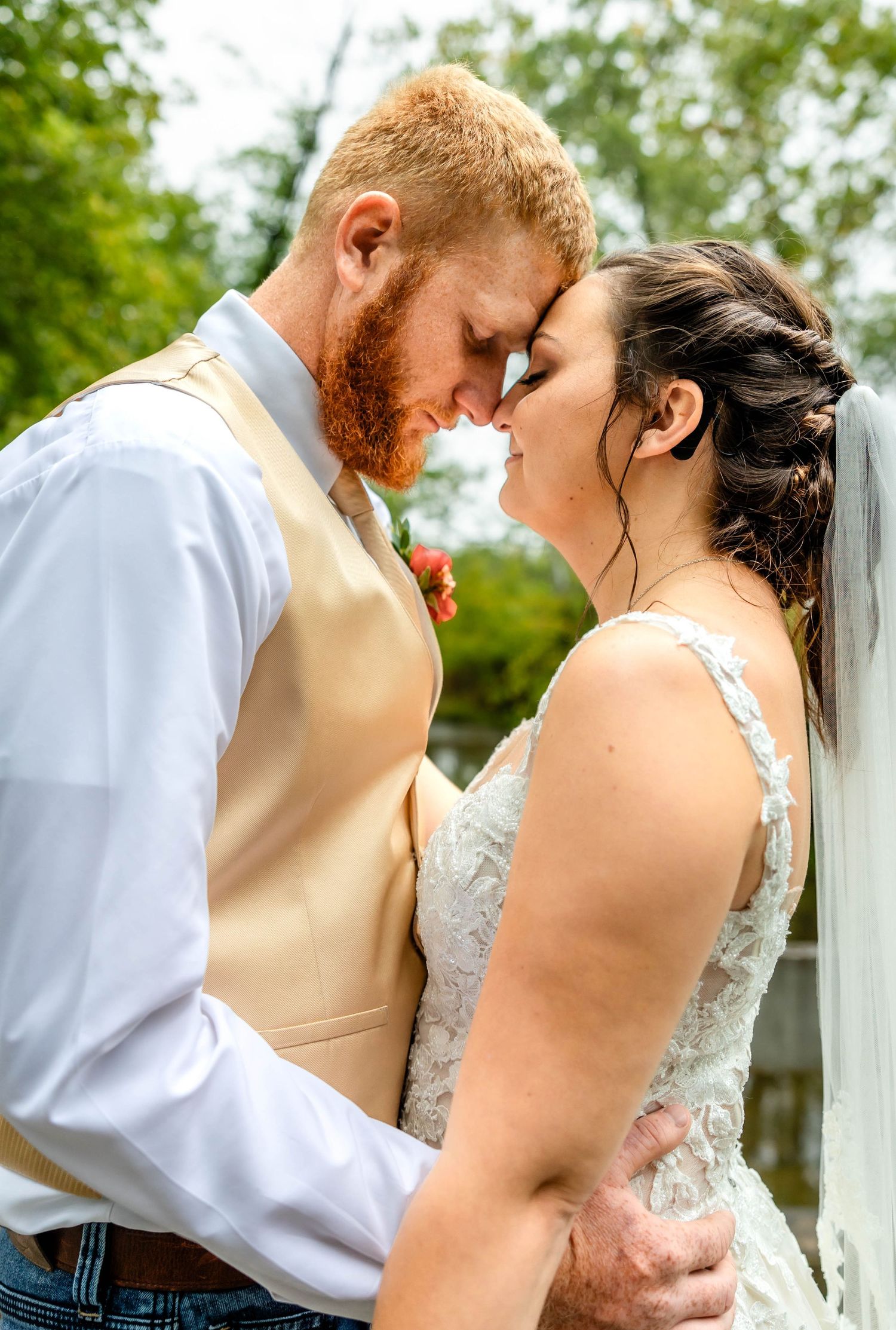 Intimate wedding portrait showing tender moment between bride and groom.