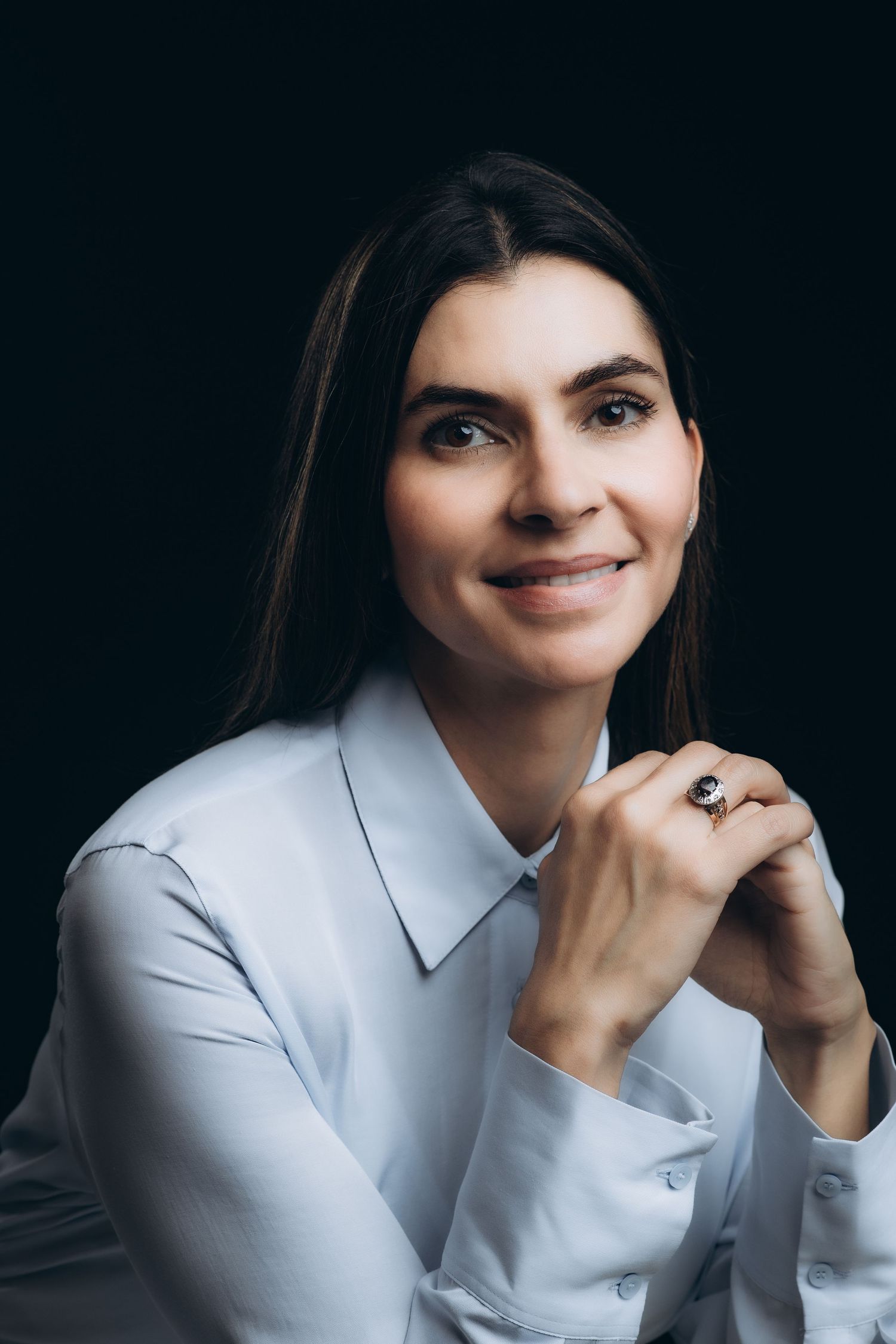 Professional studio portrait series showing close-up shots of a person in a white button-down shirt against dark background.
