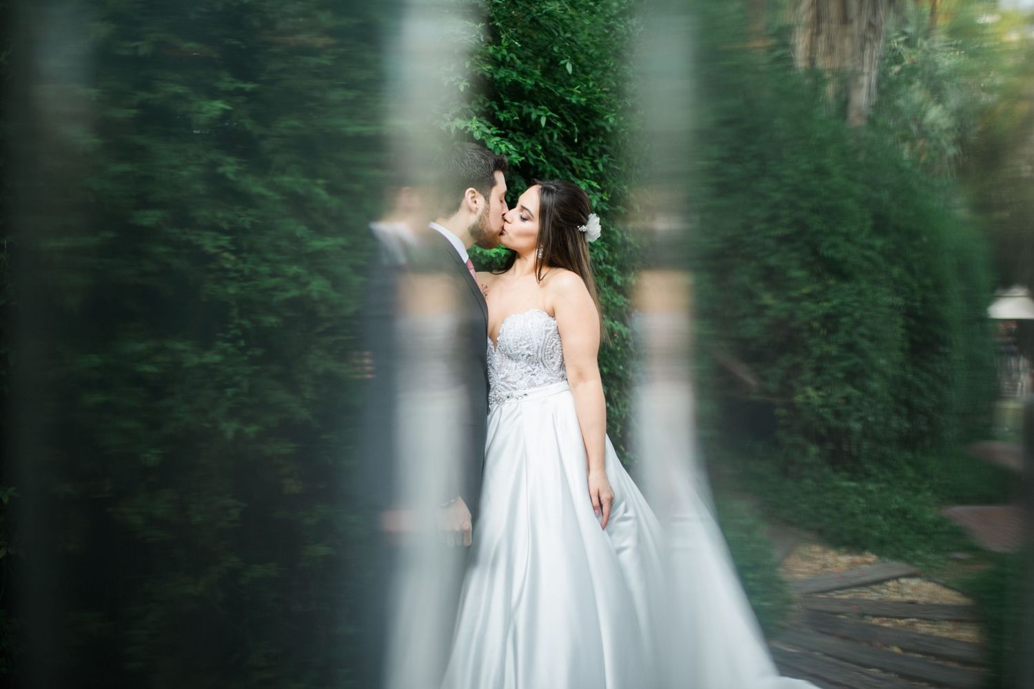 Artistic wedding photography sequence showing couple's tender moments in a garden setting.