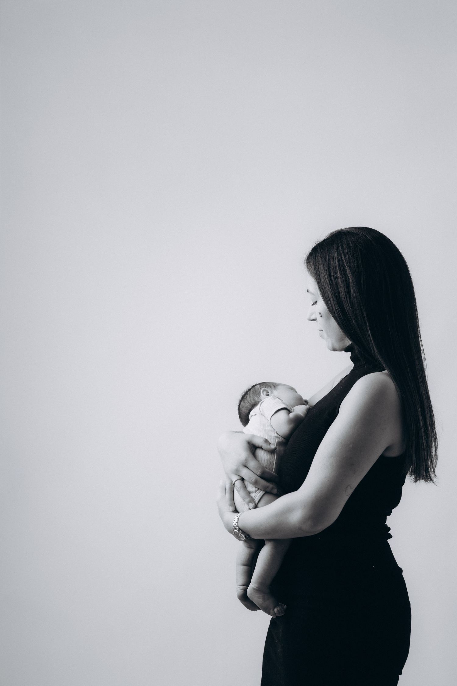 Black and white profile portraits showing emotional connection between parent and infant.