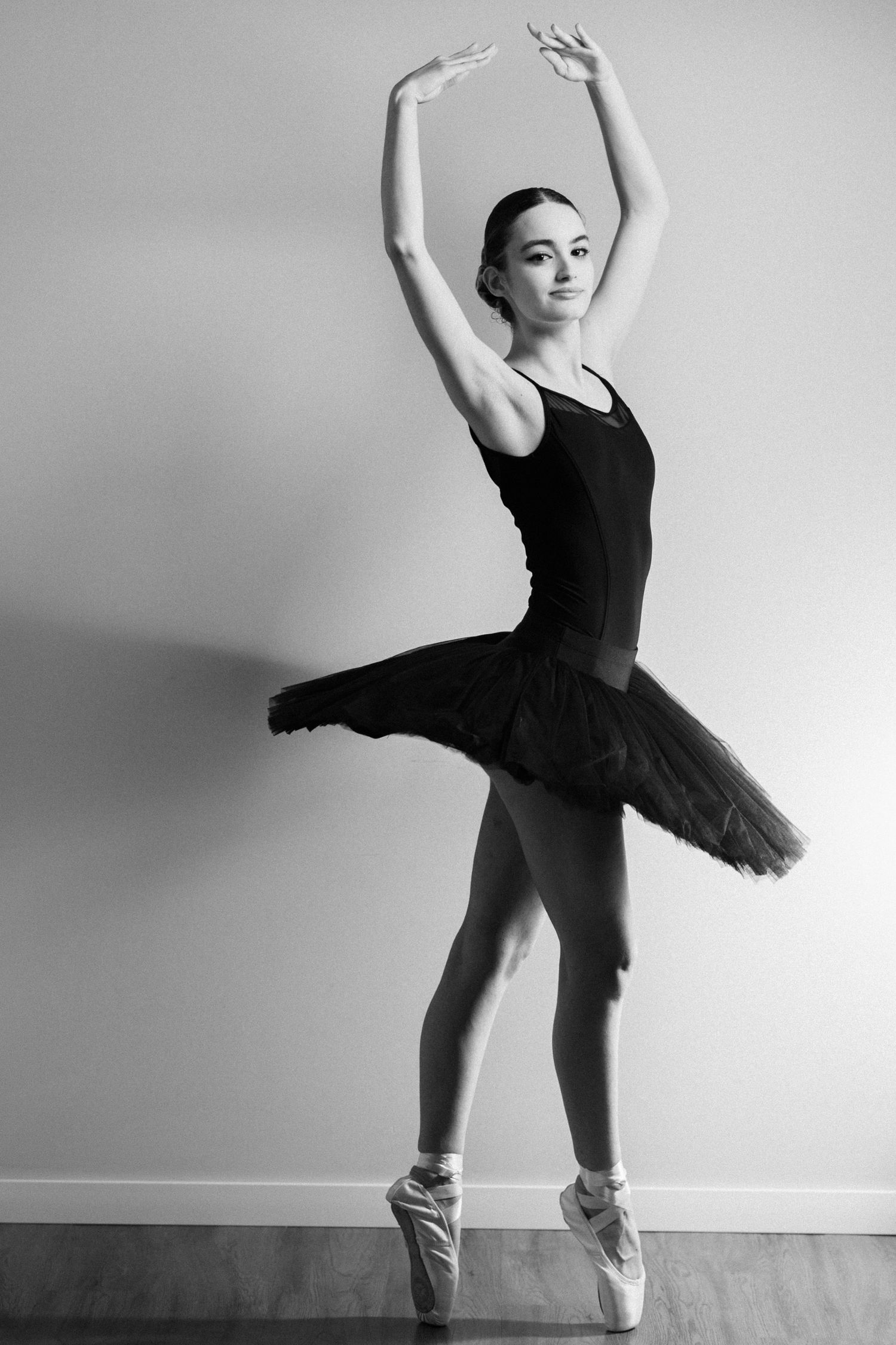 Ballet dancer in black leotard performing graceful poses in black and white photography series.