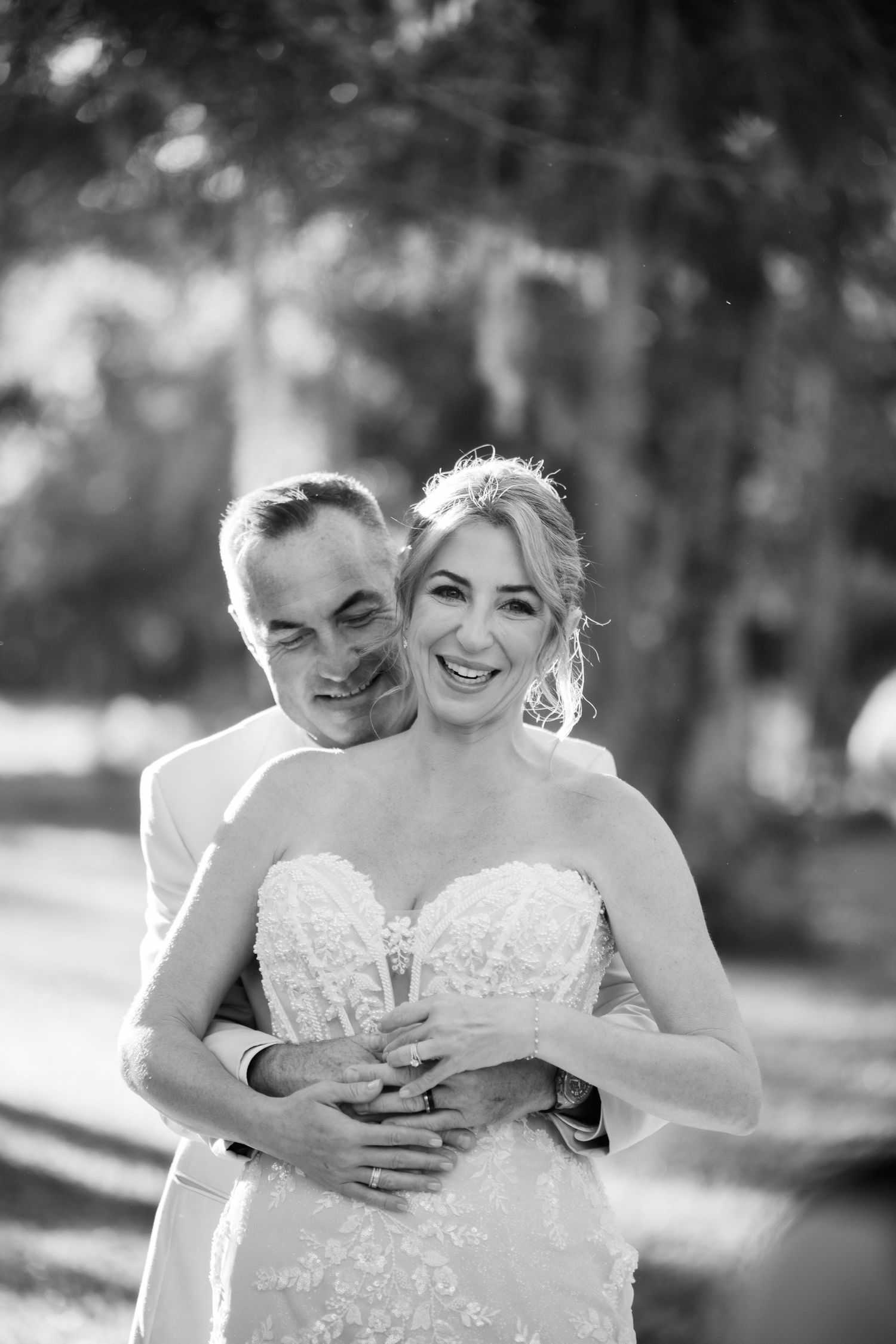 Black and white wedding portraits showing tender moments between newlyweds.