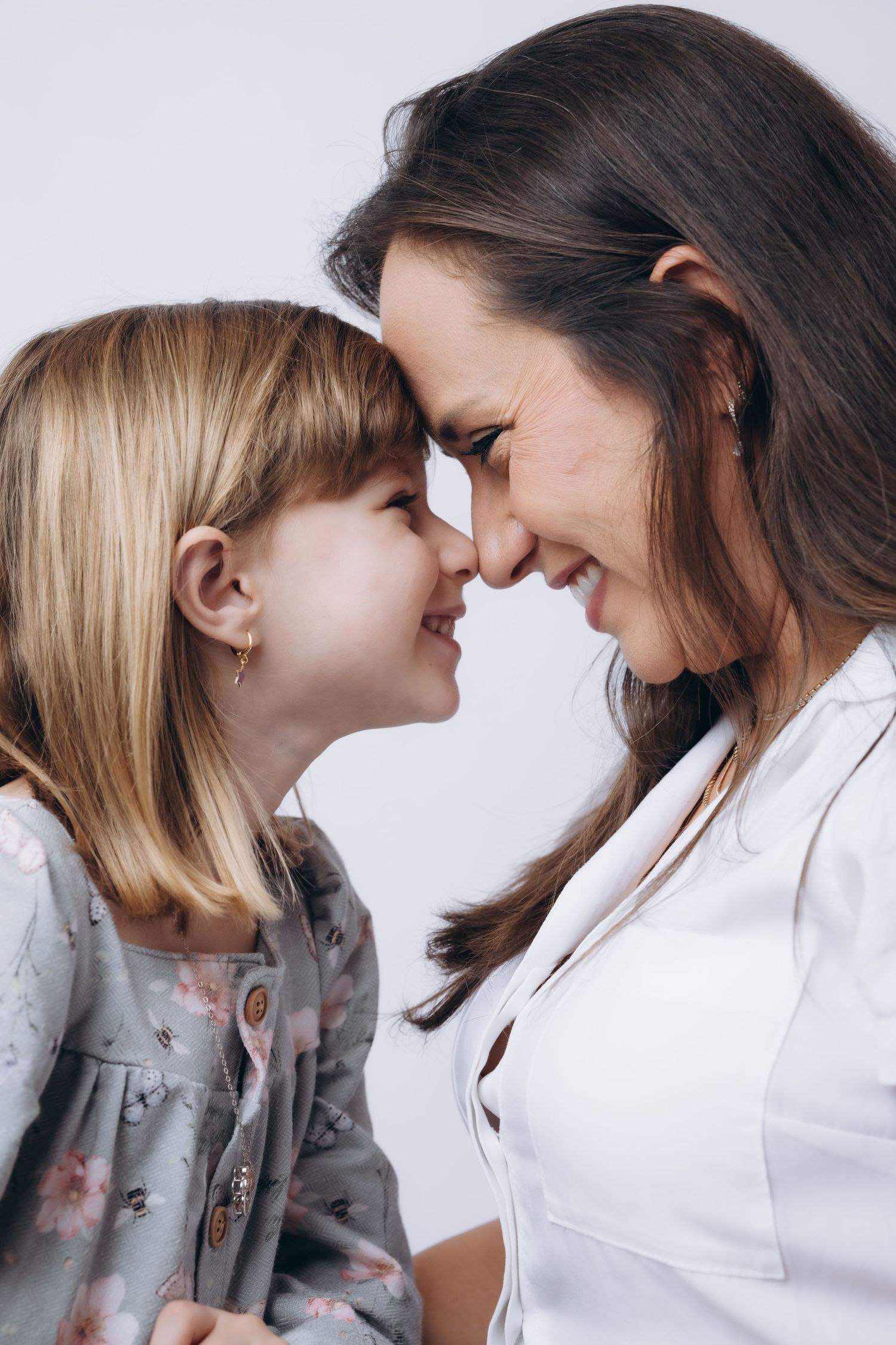 Sweet mother-daughter portrait series showing close emotional connection.