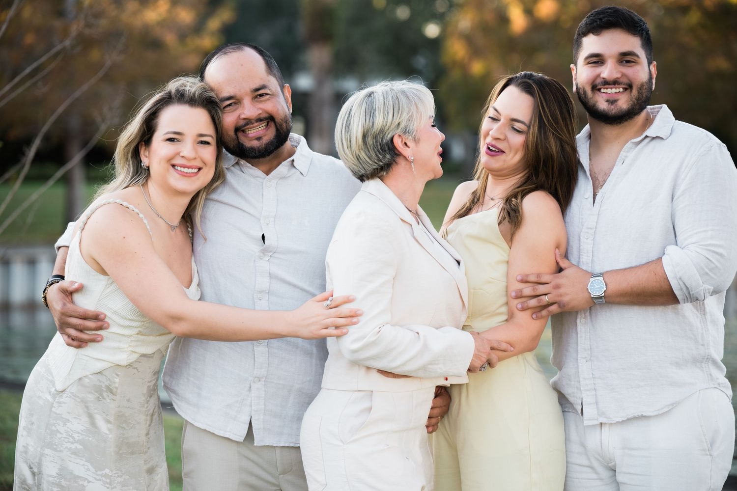 Candid moments of group laughter during outdoor family photo session.