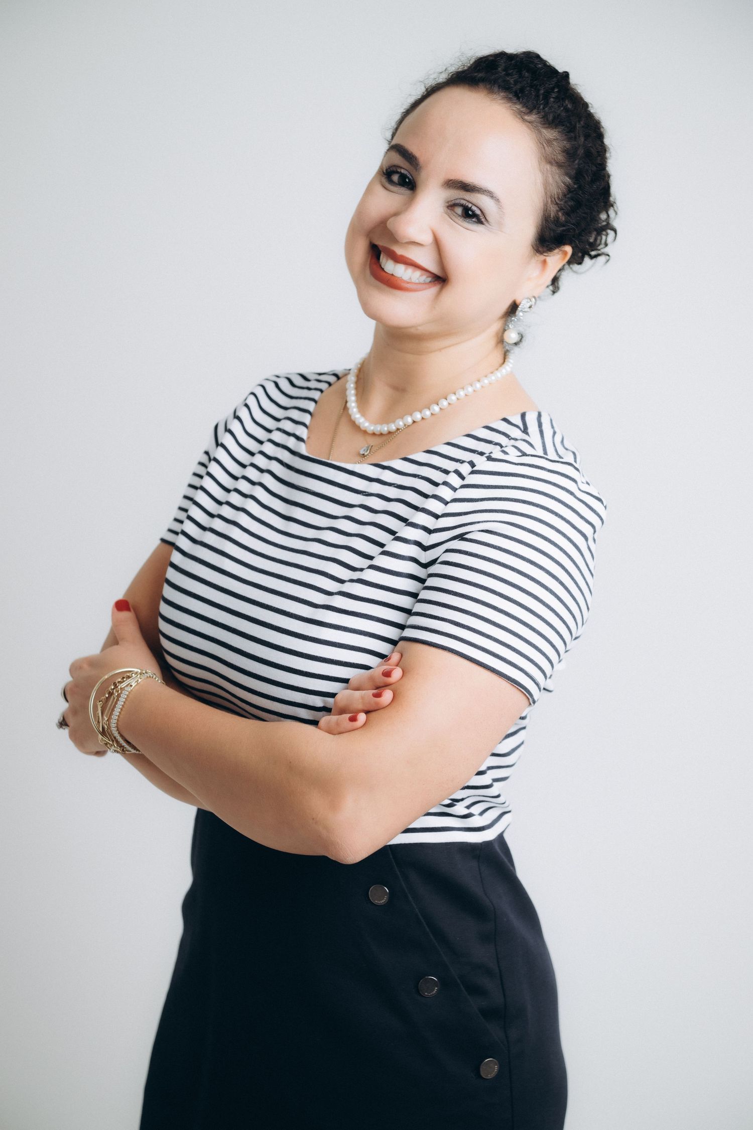 A series of fashion portraits showing someone wearing a black and white striped top against a light background.