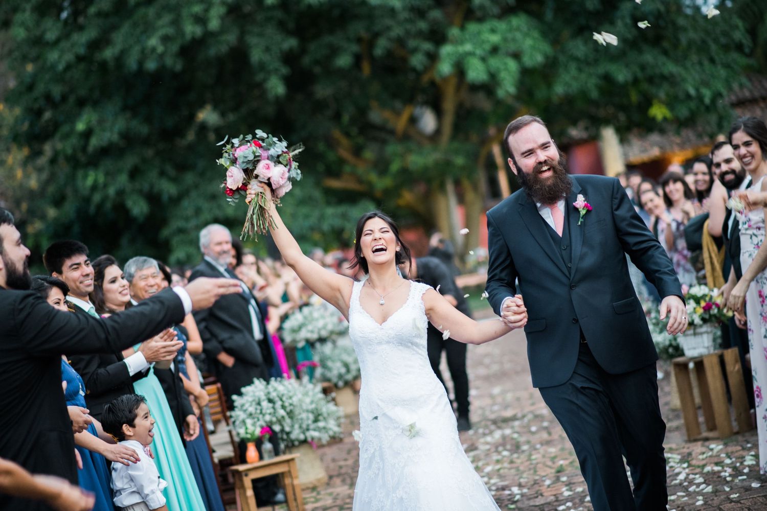 Emotional wedding ceremony moment captured in a garden setting.